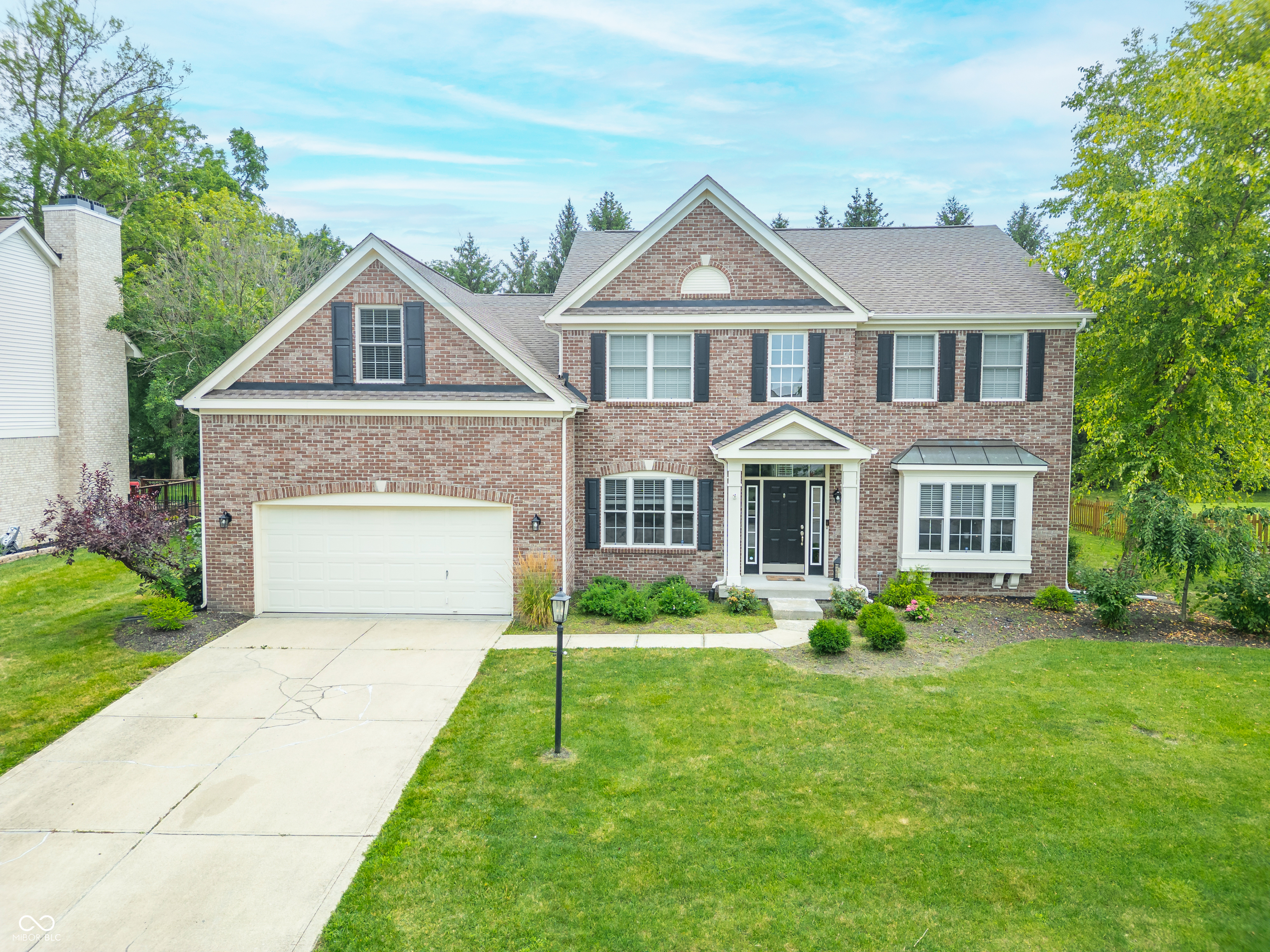 Spacious, stylish, and packed with upgrades-this stunning home in Sandstone Crossing truly has it all. Offering over 4,300 square feet of beautifully finished living space on a well-manicured 0.31-acre lot, it's designed for comfortable living and effortless entertaining.  Step inside to soaring ceilings and an open, light-filled layout. The main level features a private home office, formal dining room, and a gourmet kitchen with granite countertops, ample cabinetry, and quality appliances-all flowing seamlessly into the living area for a warm, connected feel. Enjoy your morning coffee or evening wind-down in the peaceful screened-in porch, or entertain guests on the expansive deck overlooking a private, tree-lined backyard with no rear neighbors-perfect for relaxing, playing, or gardening in total serenity. Upstairs, you'll find five generously sized bedrooms with ample closet space, including a luxurious primary suite with spa-like features and a relaxing atmosphere. The finished basement offers even more room to spread out, with 9-foot ceilings, daylight windows, and built-in surround sound-perfect for a media room, home gym, or game space. Additional highlights include an attached 2-car garage, stylish finishes throughout, and a prime location near shopping, dining, parks, and award-winning schools. Fishers, Indiana has been ranked #4 by U. S. News and World Report as a 2025-2026 top place to live in the U.S!