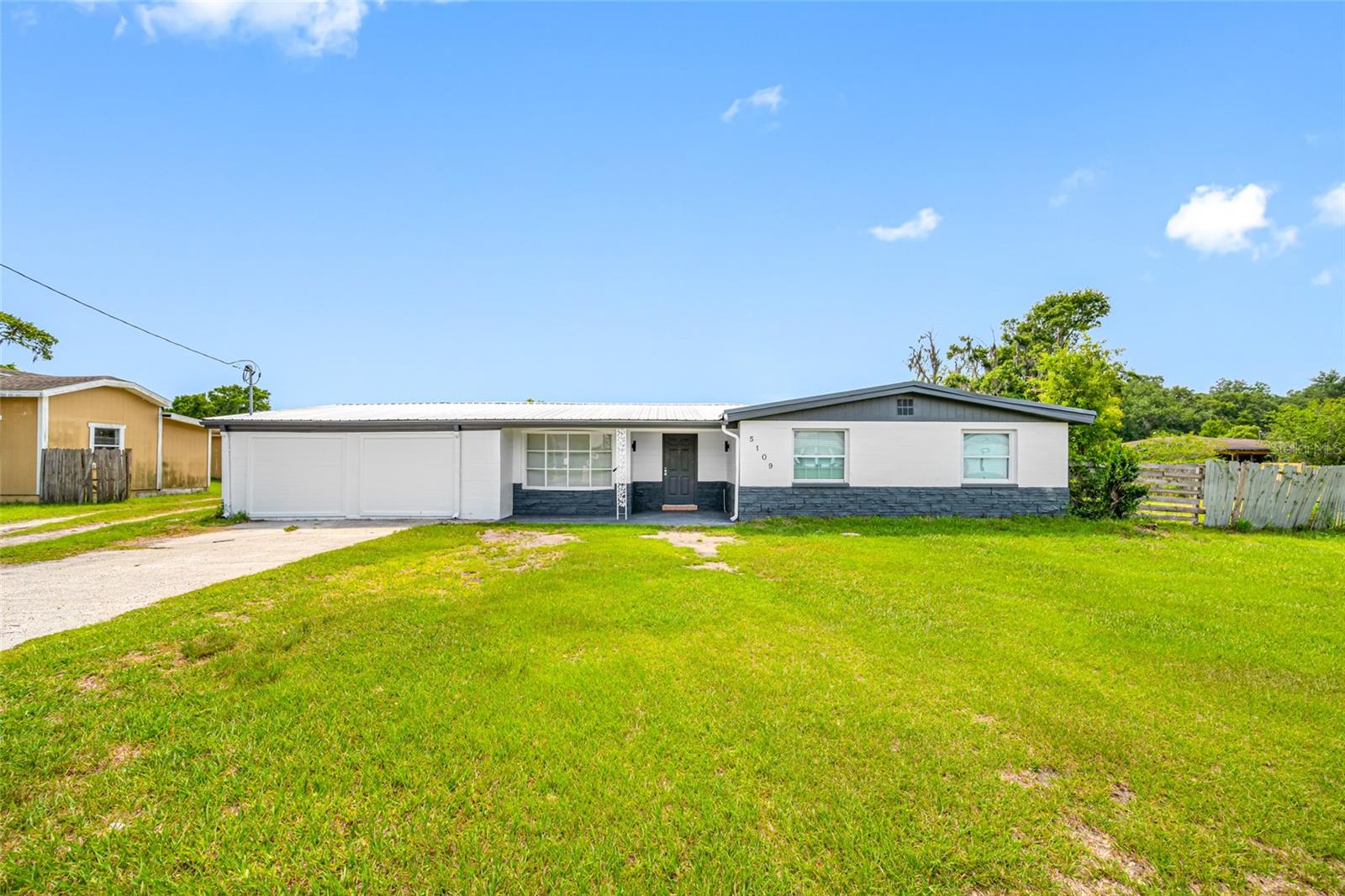 Unique opportunity for multi-generational living or an income-producing property in Plant City. Live in the newly renovated main residence while renovating the additional dwellings and creating long-term value. This versatile property includes a move-in-ready 4-bedroom, 2-bathroom main home, a renovation-ready duplex, a separate renovation-ready 1-bedroom, 1-bathroom cottage, a well shed, and a large 4-bay pole barn/carport. Whether you are looking for future rental income, guest accommodations, or space for extended family, this property offers exceptional flexibility and potential. A spacious 4-bay pole barn provides ample room for storage, vehicles, equipment, or workshop use. The property also benefits from a brand-new, fully permitted septic system, adding significant value and peace of mind for the next owner. The main home features a 2025 HVAC system and an existing metal roof that appears newer and in good condition. The duplex is served by a 2013 HVAC system. Electrical service is arranged with the front home at 5111 having its own meter and panel, while the rear 5111 residence is fed from the front home. The main 5109 residence has its own electric meter and interior panel. The shed and pole barn are not currently connected to power. The septic system includes a new 1,250-gallon tank, a new 540-gallon main lift station, and a new 540-gallon pump station serving the smaller residences. Private financing may be available with 30% down, a term of one to three years, 2.5 points, and 10% annual interest. Proof of funds for the required down payment must accompany any offer requesting seller financing. Seller is an investor and has never occupied the property. All room dimensions are approximate and are based on the main residence.