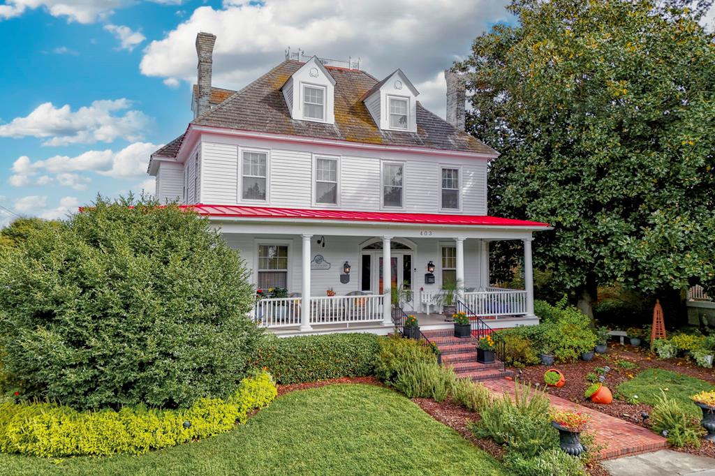 "Bay Haven" Grande Dame of Cape Charles sits on a double lot on the corner of iconic Tazewell Ave & Peach Street. Experience timeless elegance in this stunning 1906 Colonial Revival home w/ 4739 sq ft w/ 5 bedrooms ,7.5 baths & guest cottage. Stately 3-story home blends historic charm w/ modern comfort. The massive kitchen features cathedral ceilings & high-end finishes, while spacious living areas showcase classic architectural details throughout. A sweeping southern wraparound porch & beautifully landscaped gardens create an inviting outdoor retreat. Just blocks from the Chesapeake Bay, sandy beaches, vibrant downtown, & steps from the town park's concerts & events, this home offers a rare combination of space, character, & coastal lifestyle in one of Virginia's most beloved small towns.