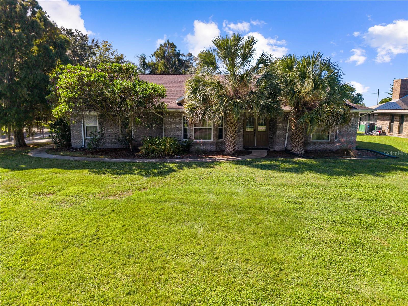 CANAL FRONT TO LAKE TOHO!!! Beautifully remodeled 4 bedroom 2 1/2 bath home with a screened in swimming pool! Florida room that was remodeled into a summer kitchen equipped with a vented grill, mini fridge, bar with sink and a mini split a/c for comfort with double sets of sliding glass doors going onto the pool deck.  The kitchen features skylight, espresso cabinets, granite counters, a wine fridge, built-in wine rack stainless steel appliances, built in oven, built in microwave, cooktop, breakfast bar and eating space! You will fall in love with the hard wood and modern tile flooring throughout the home. The previous owner put in all new interior doors, ceiling fans and lighting. The primary bedroom comes equipped with dual sinks, a claw foot bathtub, and a walk-in shower The roof was replaced in 2019.  There is a fire pit deck area with plenty of room for outside seating outside the pool enclosure.  This property has a large, fenced backyard with many fruit trees including Loquat, Peach, Papaya, Orange, Jack Fruit, Blueberry bush, Lychee, Mango, Lemon, 2 Avocado’s and a Banana tree all on an oversized corner lot with a 2-car garage and parking pad for up to 4 vehicles! Private community boat ramp is next to the house, and there is NO HOA FEES! The home is conveniently located near the Florida Turnpike with access to all major roads throughout central Florida.