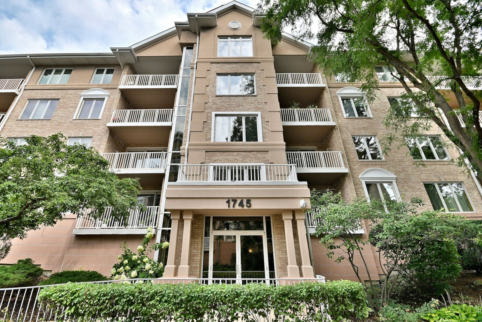 Welcome to this exquisite three-bedroom, two-bath corner unit condo, ideally situated on the top floor to provide maximum privacy and abundant natural light. Enjoy picturesque, unobstructed views of a serene, swan-filled pond from multiple vantage points throughout the home. The open floor plan features soaring ceilings and a spacious living area that flows seamlessly into the dining and kitchen space-perfect for everyday living or entertaining. Inside, you'll find elegant marble flooring, freshly painted walls, updated kitchen appliances, and the convenience of in-unit laundry. The kitchen offers generous cabinet and counter space, making meal prep a breeze. The luxurious primary suite includes its own private balcony, perfect for relaxing and taking in the scenic surroundings. Two additional, generously sized bedrooms offer flexible options for guests, a home office, or additional living space. With two private balconies, you'll enjoy plenty of outdoor space to unwind. The well-maintained community features walking paths, a tranquil pond with a charming gazebo, beautifully landscaped grounds, and the convenience of a heated garage with additional storage. Combining comfort, style, and natural beauty, this rare top-floor unit is a true gem. Don't miss your opportunity to make it your new home!