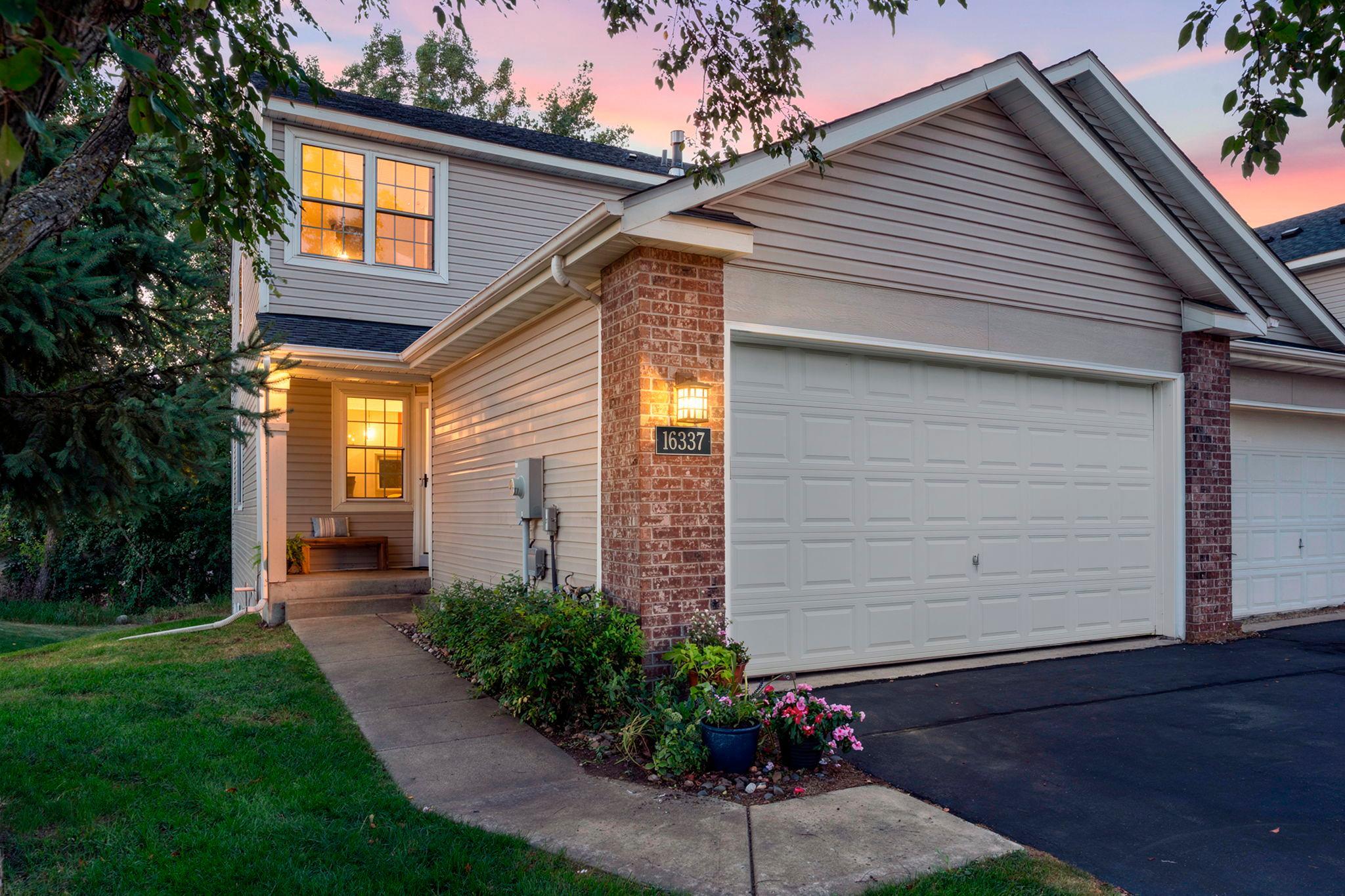 Welcome to this stunning three-bedroom, four-bathroom end-unit townhome in a quiet Lakeville community. This beautifully updated home features a light-filled, open layout with new luxury plank flooring throughout the main level. The remodeled kitchen is a true highlight, showcasing custom cabinetry with soft-close drawers, Cambria countertops, a spacious island with breakfast bar seating, and stainless steel appliances, including a Fisher & Paykel refrigerator, two-drawer dishwasher, and induction range. The dining area features impressive 18-foot ceilings and a statement chandelier, while the inviting living room offers abundant natural light, a cozy gas fireplace, and access to the maintenance-free deck (2024). The main-level primary suite includes a private full bathroom with a jetted tub, separate shower, dual-sink quartz vanity, updated lighting, and a spacious walk-in closet. A convenient laundry room with updated cabinetry, countertop, and Samsung stackable washer and dryer completes the main level. The upper level features a versatile loft with built-in desk space and cabinetry, a second bedroom with a walk-in closet, and an updated full bathroom. The finished lower level provides additional living space with a family room, built-in cabinetry and workspace, a third non-conforming bedroom with a walk-in closet, and a full bathroom. This flexible floor plan offers the potential to add one or even two additional bedrooms by enclosing the loft or reconfiguring the lower-level non-conforming room, giving buyers multiple ways to expand the home. Additional updates include new carpeting (2020), deck entry door and Larson storm door (2021), Anderson front screen door (2026), and water heater (2019). Enjoy maintenance-free living with HOA coverage including lawn care, snow removal, sanitation, gutter cleaning, dryer vent cleaning, tree maintenance, and more. Ideally located near shopping, dining, parks, and local amenities, this turnkey home is a must-see!