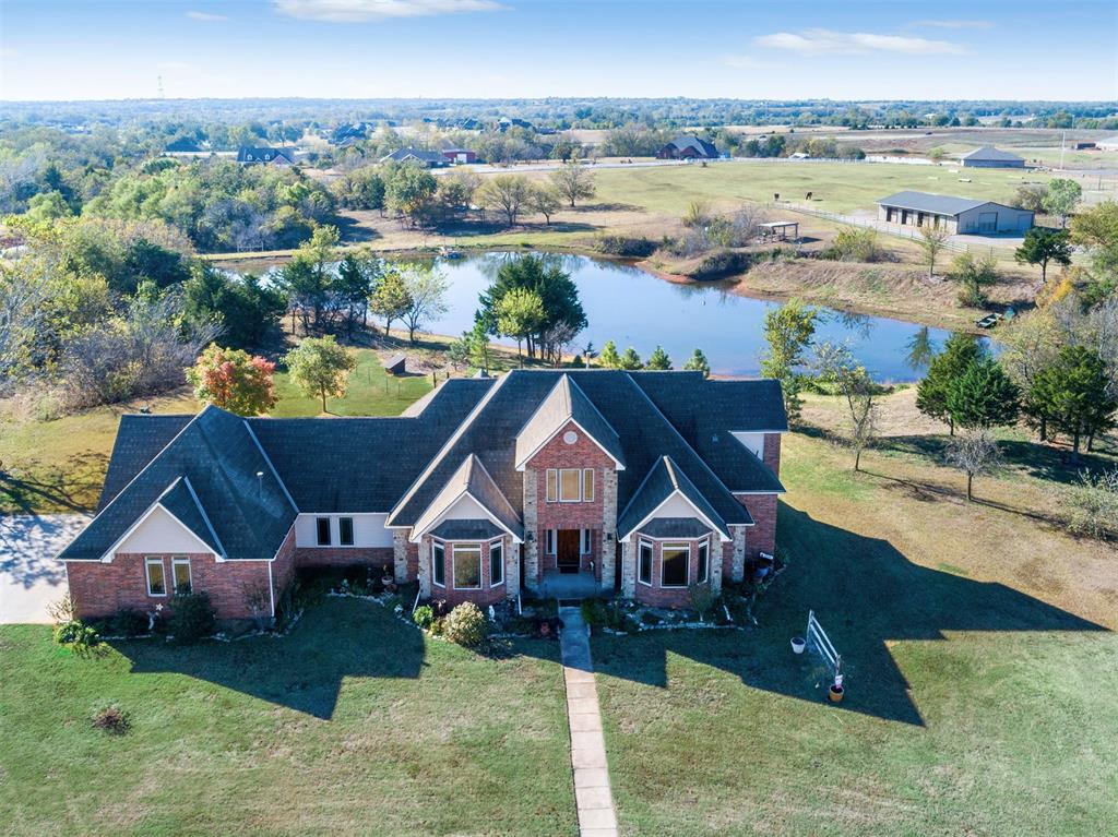16 ACRES & SCENIC FISHING POND---40 X 60' THREE STALL, BREEZEWAY BARN WITH WASH RACK, ATTACHED EQUIPMENT STORAGE and CLIMATE-CONTROLLED TACK & FEED ROOM---90 X 200' LIGHTED RIDING ARENA, COVERED HAY STORAGE & IT'S OWN GATED ENTRY TO THE HORSE FACILITIES. ZONED AG-RESIDENTIAL FOR LOWER PROPERTY TAXES. This custom-designed home features an awesome floor plan with 2 bedrooms and loft living space upstairs and 2 downstairs along with a GREAT KITCHEN including granite, stainless, smooth-top cooktop and warming drawer. BEAUTIFUL WOODWORK throughout the home, 8' INTERIOR DOORS DOWNSTAIRS, including a study and 3 living areas, 2 water heaters, whole-house water softener and inground sprinklers. The pond is STOCKED WITH BASS & CRAPPIE. Fish from the floating dock or RELAX IN THE GAZEBO. Hay barns and loafing shed complete the picture with covered storage for 23 large bales of hay. Train in your own 90x200 arena! Ride on the gently rolling pastures or trailer 10 minutes down the road to Lake Thunderbird State Park where you'll find 11 miles of scenic trails Enjoy the privacy and security of being located on a quiet street with 2 automatic gates - all convenient to shopping and the University of Oklahoma, less than 5 miles from this exclusive offer! PER THE SELLERS, SHOWINGS TO PRE-QUALIFIED BUYERS ONLY, NO EXCEPTIONS.  Internet is OEC Fiber.
