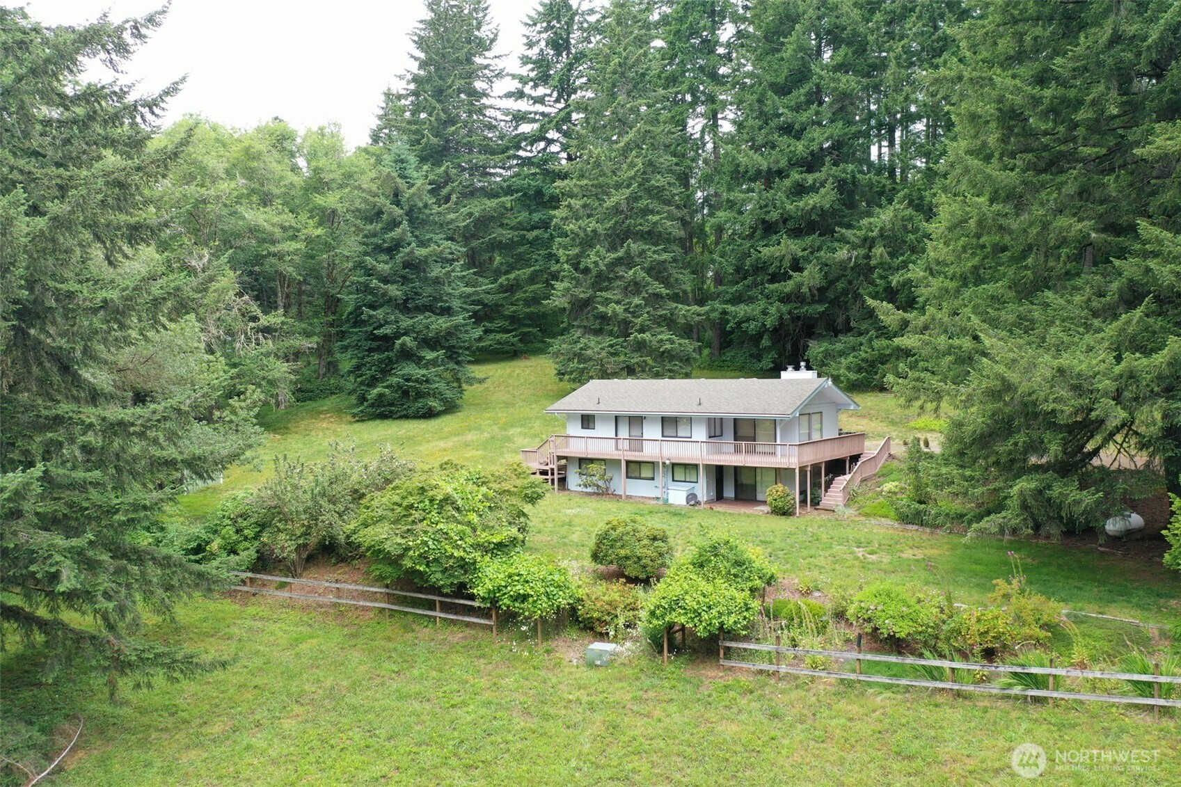 One owner, this is a beautiful home with  4 bedrooms & 2 living room spaces. Nicely treed parcel with seclusion and still close in. Nice 2 car garage with breezeway, large yard, deck ( fresh new boards and paint) and lower patio. The shop/barn could easily house a horse ,goats or make a mechanic shop. The options are endless here, come take a look today! Fresh exterior paint and new deck & railing.