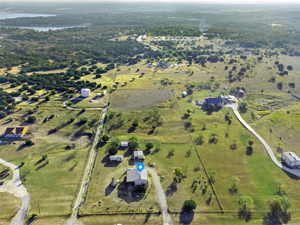 Discover your serene getaway on 5 acres of picturesque land, just moments from the beautiful Lake Whitney. This unique barndominium-style home includes a metal shop with electric, metal shed, and a large carport big enough to fit an RV making it the perfect retreat for relaxation or adventure. Whether you seek a permanent residence or a weekend escape, this property near Lake Whitney and Laguna Park is the ideal spot to unwind and enjoy the beauty of the great outdoors. Don’t miss out on this incredible opportunity!