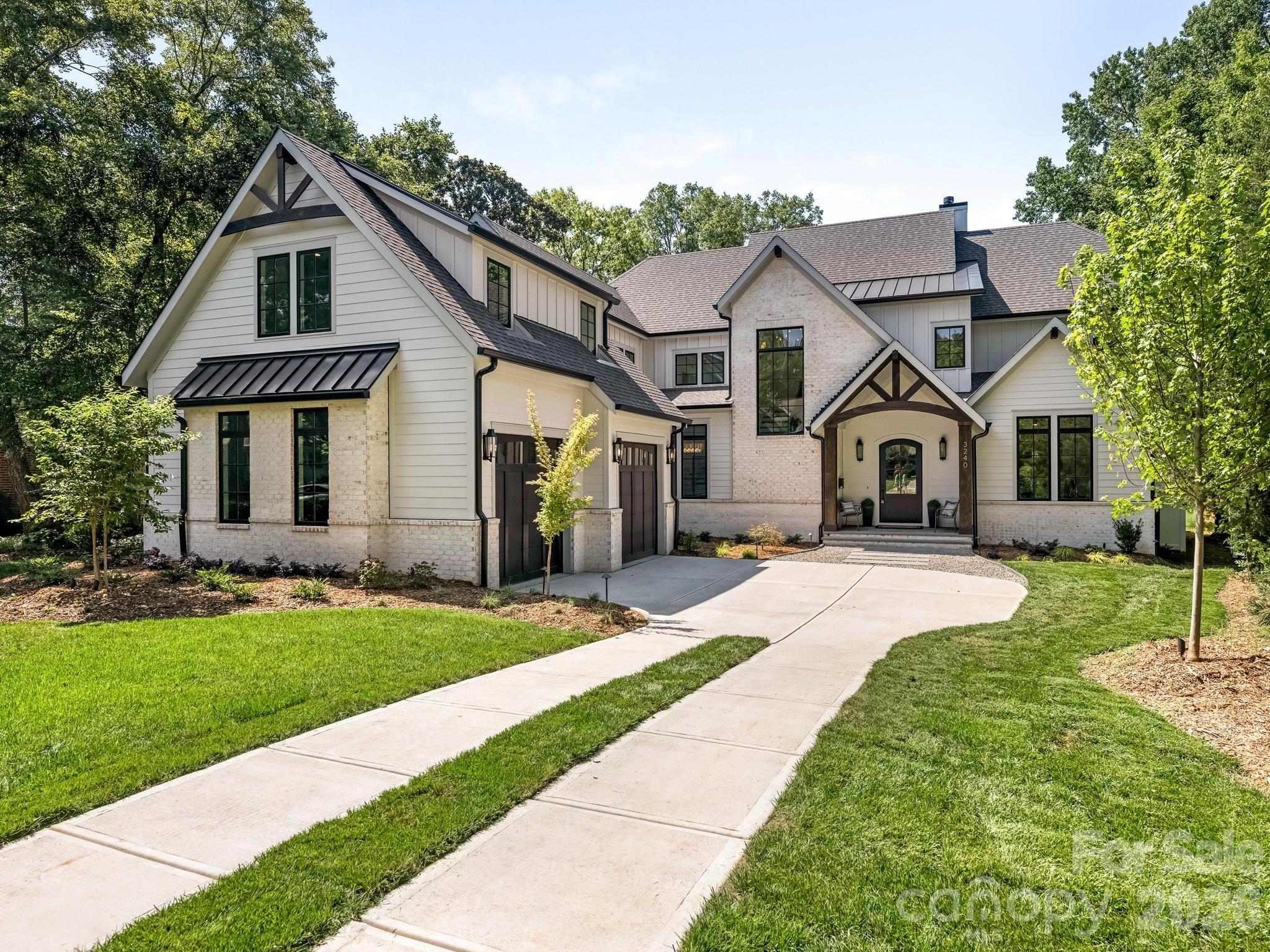 This exceptional new two-story custom home blends contemporary design with timeless warmth on one of Charlotte's most desirable locations on a beautiful tree lined street in Sedgefield.  Designed with both luxury and livability in mind, the home features expansive open-concept living spaces, curated designer finishes, and beautiful white oak accents throughout.  At the heart of the home is a chef's kitchen with high end appliances and custom cabinetry that flows seamlessly into the eat-in breakfast nook and light filled living space.  Large sliders lead to a covered rear porch with a gas fireplace, creating an effortless connection between indoor and outdoor living.  The thoughtfully designed floor plan includes five bedrooms, five and a half bathrooms, a private office, loft, and bed/bonus room.  The spacious primary suite offers a spa-inspired retreat with stunning tilework, a coffee nook, closet laundry connections, and elevated finishes. A well-appointed mudroom with built-ins and a desk/drop zone adds practical organization just off the oversized two car garage.  The home is very energy efficient - with foam insulation in the attic and a sealed, encapsulated crawl space with a dehumidifier.  It is just minutes away from uptown, several parks, and a plethora of restaurants!   The home is protected by a StructSure 1-2-10 Home Warranty to be passed to the buyer at closing.  Your next home awaits!