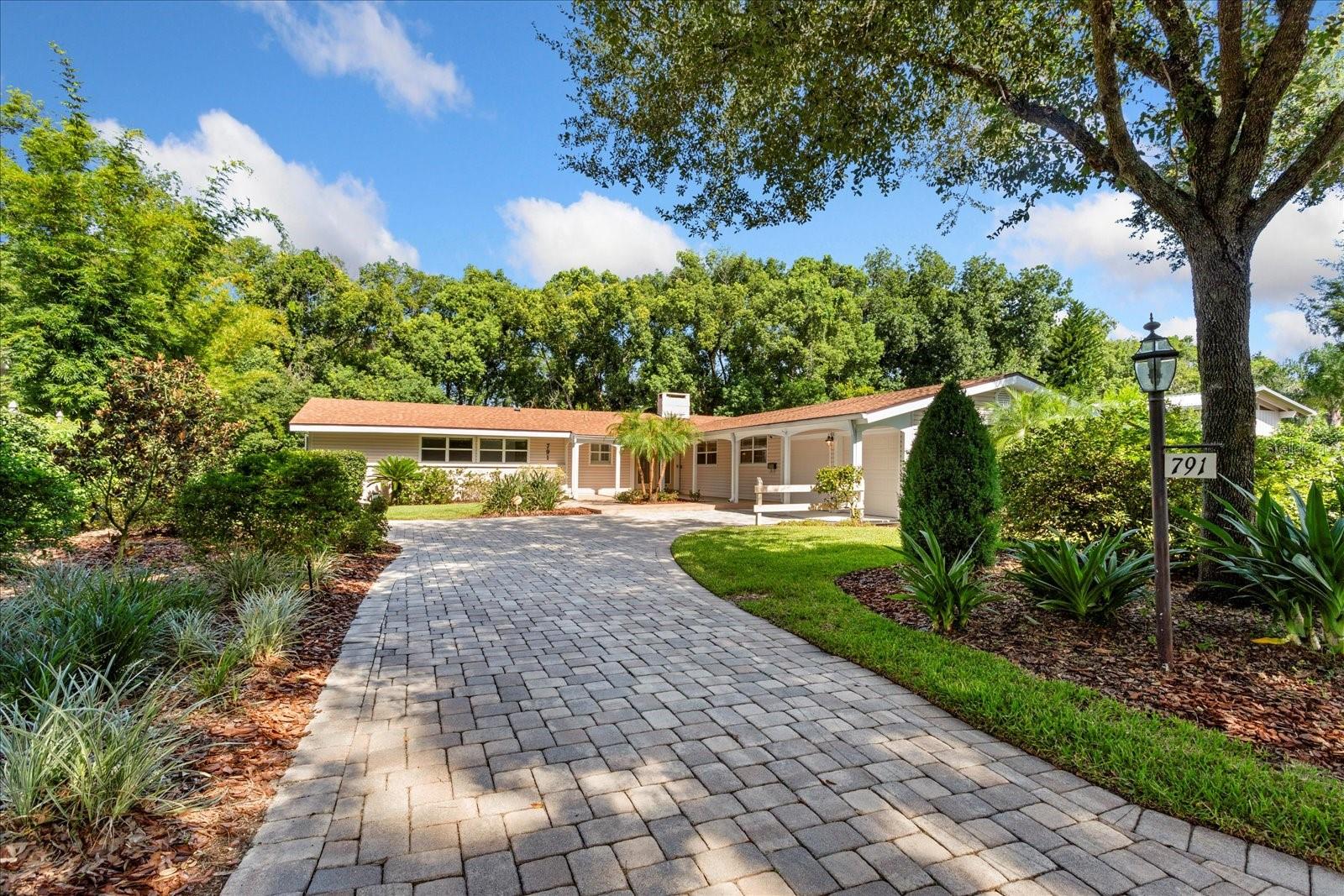Discover a rare opportunity in Dommerich Woods, a distinguished and established Maitland neighborhood celebrated for its rich heritage. Situated on .33 acre of lushly landscaped grounds, this remarkable property welcomes with paver drive and enjoys a tranquil setting along a
peaceful creek connecting Lake Minnehaha and Lake of the Woods - creating an atmosphere of natural elegance and privacy.
Re-roofed in 2023, this expansive 5 bedroom, 3 1/2 bath residence offers 4,144 HSF, and WHOLE HOUSE WATER SOFTNER, showcases a versatile TWO-LEVEL design, perfectly suited for refined living and gracious entertaining. The main level opens with a foyer leading into a bright, open living and dining area, where CEILING FANS throughout the main level add comfort and elegance. From here, step out onto the COVERED UPPER DECK with sweeping views of the SCREENED POOL, TROPICAL GARDEN, and serene backyard retreat - an ideal setting for morning coffee or evening gatherings.
At the heart of the home, the GOURMET KITCHEN blends style and functionality with SOLID WOOD CABINETRY, a built-in WINE REFRIGERATOR and WINE RACK, granite countertops, and a CENTER ISLAND with SEATING, and REVERSE OSMOSIS WATER SYSTEM under the DOUBLE SINK. The adjacent laundry room offers exceptional storage, keeping household essentials organized. For added convenience , a two-car garage with built-in cabinets and workshop area, adjoins the spacious laundry room that has granite counters and washer and dryer. Also on the main level , adjacent to the primary bedroom with en-suite bath, a bedroom has been thoughtfully converted into a large closet featuring a CUSTOM CLOSET system, providing abundant space for wardrobe organization.
Both levels feature inviting WOOD-BURNING FIREPLACES that add ambiance to the living spaces. On the lower level, a spacious family room, kitchenette, study/library/office, two bedrooms, full bath and half bath provide the perfect complement to easy living. Along the
hallway, built-in wood shelving creates a refined showcase for books, art, or personal collections. While one bedroom includes a custom built 
in desk- ideal for work or study, a second bedroom adds flexibility for creative projects. This level opens onto the screened pool and patio area, designed for seamless indoor-outdoor living. Outside, tropical plantings, METERED IRRIGATION, and a winding private walkway leads along the soft murmur of the BORDERING CREEK. An added bonus is the storage room located below the kitchen which is approximately 375 sq.ft.  Whether hosting guests or enjoying a quiet evening, this private oasis offers the ultimate backdrop for relaxed Florida living.
Enjoy the opportunity to join the Dommerich Beach Civic Association with membership options including access to a private picnic area, boat ramp, canoe and kayak storage, and unforgettable evening sunsets. With its rare combination of design, flexible spaces, and an idyllic setting , this residence presents a unique opportunity to experience the very best of Maitland and Central Florida living. All this is convenient to some of Central Florida's finest schools, shopping, restaurants, parks, entertainment, businesses and more!
