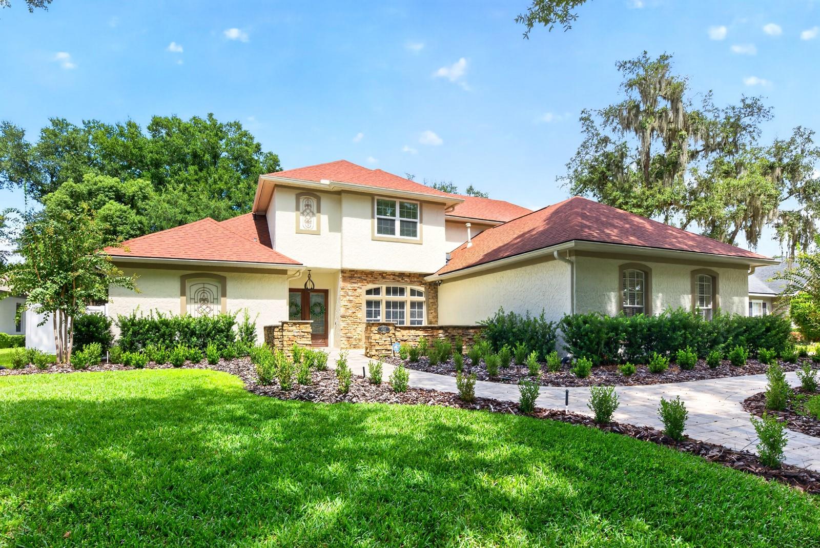 UPDATED, ELEVATED & DESIGNED FOR FLORIDA LIVING – this gorgeous 4-bedroom, 4-bath POOL HOME on a .37 ACRE LOT with a 3-CAR SIDE-ENTRY GARAGE is set along the tree-lined streets of GATED STONEHURST in sought-after OVIEDO! Major improvements include a NEW A/C (2026), NEW PAVER DRIVEWAY & WALKWAY (2026), refreshed LANDSCAPING (2026), a stunning KITCHEN RENOVATION (2025), UPDATED BATHROOMS (2025), NEW FLOORING THROUGHOUT (2025), refreshed BUILT-IN FIREPLACE/SHELVING (2025), UPDATED WATER HEATER (2022) and a NEWER ROOF (2021). Light, bright and beautifully curated, the interior pairs comfortable luxury with COFFERED CEILINGS, CUSTOM MILLWORK and an easy-flowing layout designed for everyday living and entertaining. Formal living and dining rooms offer dedicated gathering spaces, while the heart of the home opens into a spacious family room and showpiece kitchen. The remodeled kitchen delivers endless storage, a GAS COOKTOP, CUSTOM RANGE HOOD, upgraded BUILT-IN STAINLESS STEEL APPLIANCES and an extended BREAKFAST BAR, all overlooking the main family room. A built-in feature wall with a gas fireplace and a large picture window create an inviting space to come home to everyday. Your oversized MAIN FLOOR PRIMARY SUITE offers privacy and a SPA-INSPIRED EN-SUITE BATH, while upstairs you will find three additional bedrooms, two full baths and a comfortable LOFT for flexible bonus space. A dedicated laundry room plus the mudroom/drop zone add everyday function at the garage entry. Step outside into a true BACKYARD OASIS with a large COVERED PAVER LANAI, poolside BUILT-IN GRILL/SUMMER KITCHEN, OPEN AIR POOL & SPA, multiple seating areas and green space, all surrounded by VINYL PRIVACY FENCING. Stonehurst offers its residents a gated entrance, mature trees, park and playground, with a fantastic location just off Tuskawilla Road near Red Bug Lake Road, SR 417 and SR 426. Zoned for A-RATED SCHOOLS Red Bug Elementary, Tuskawilla Middle and Lake Howell High. Luxury upgrades, versatile living spaces, a private pool and spa, and a prime Oviedo location make this one a must see!