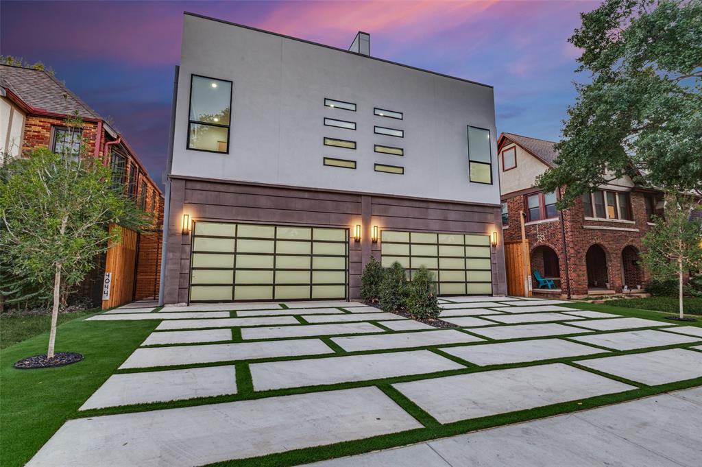 Experience exceptional modern luxury at 4044 Hawthorne Avenue, a striking 4,342 SF contemporary residence designed for sophisticated living and unforgettable entertaining. Spanning three thoughtfully designed levels, this 4-bedroom, 5.5-bath home features two primary suites, a private glass-enclosed office, multiple living spaces, and an expansive rooftop terrace.Inside, soaring ceilings up to 12 feet, wide-plank hardwood floors, custom windows, designer lighting, and a dramatic floating wood-and-glass staircase create an immediate sense of architectural distinction. The open living area is anchored by a floor-to-ceiling statement fireplace and flows into a spectacular chef's kitchen featuring an 11-foot waterfall island, warm custom cabinetry, dramatic stone surfaces, premium gas appliances, built-in refrigerator, extensive storage, and dry bar.Accordion-style glass doors connect the main living space to a covered patio, outdoor kitchen, and private fenced backyard for seamless indoor-outdoor entertaining.The primary suite is a true retreat with a private balcony, oversized walk-in closet, and spa-inspired bath featuring dramatic stonework, dual vanities, a freestanding soaking tub, fireplace feature, and oversized glass-enclosed rainfall shower. A second primary suite provides exceptional flexibility for guests or multigenerational living.The third level offers a private lounge, wet bar, and impressive covered rooftop terrace ideal for sunset gatherings and entertaining. Smart-home features, energy-efficient systems, gated entry, an 8-foot privacy fence, multiple outdoor spaces, and an oversized 2-car garage with contemporary glass doors complete this distinctive residence.Bold architecture, exceptional finishes, and resort-inspired spaces make this a truly memorable Dallas home.