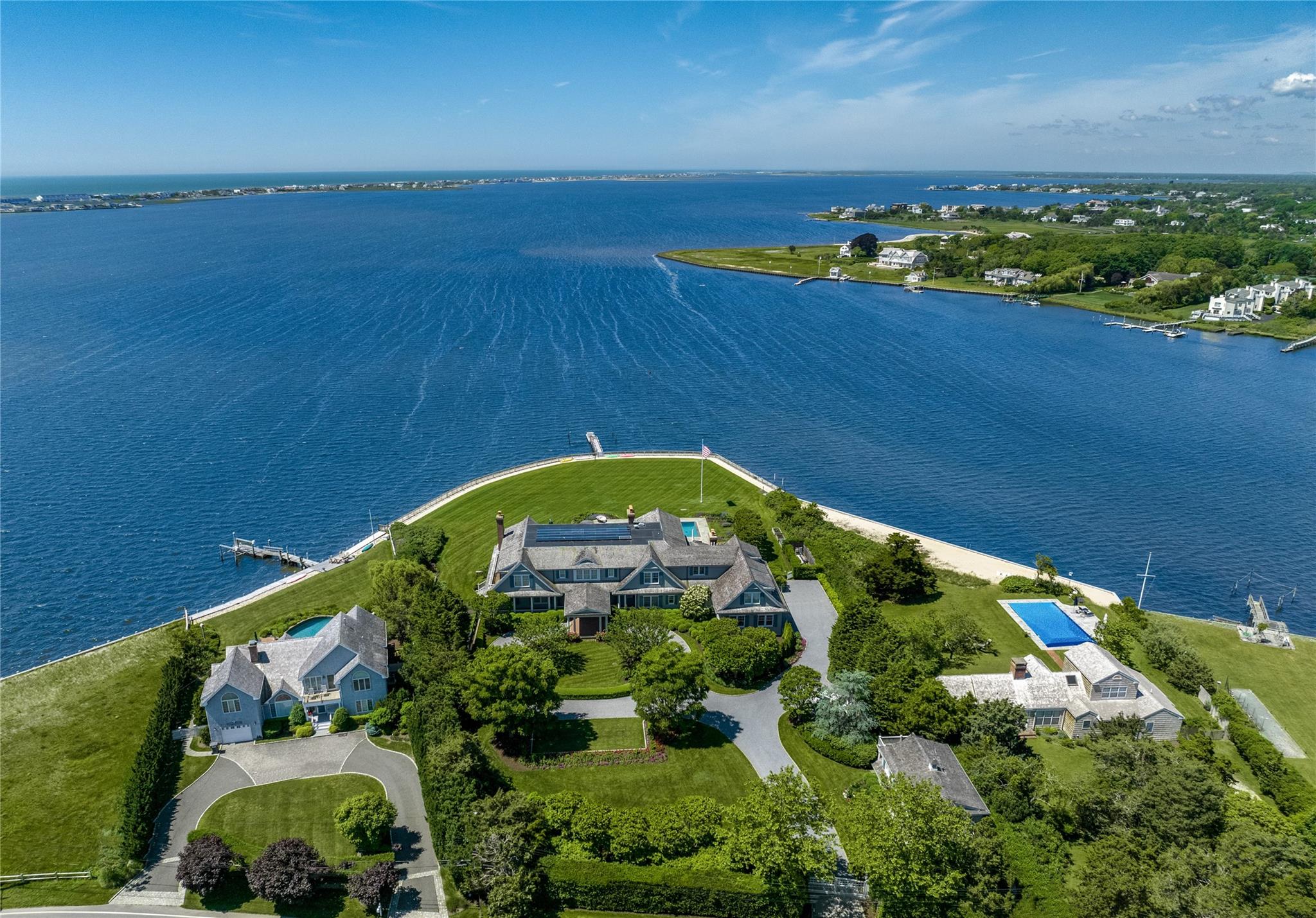 Introducing The Point, an exquisite waterfront estate situated on +/- 2 acres with +/- 380' of frontage on Moriches Bay, a private dock and separate carriage house. Located on one of the most premier waterfront sites in the Hamptons, this brilliantly designed and executed custom home by architect Craig Arm and appointed by interior designer, Bunny Williams, features an 8 bedroom, 9.55 bath main house and 2 bed, 2 bath carriage house with the finest materials and details throughout. Ideal for entertaining on any scale - inside and out - this stunning house is complete inside with a state of the art dream kitchen, butler’s pantry, atrium, morning room, formal dining room, great room, study, and gym. Outside, enjoy this peninsula-like exclusivity in the multiple covered sitting areas, by the 50 x 24 gunite zero-edge pool with built in spa, and take in the beautiful panoramic views of both the sunrise and sunset. Additional features include geothermal heating and cooling and generator. With close proximity to Westhampton Country Club, the vibrant Main Street of Westhampton Beach for boutique shopping, casual and fine dining, Performing Arts Center, and Sunset Theatre, and Dune Road's world-class ocean beaches, this spectacular waterfront estate is not to be missed!