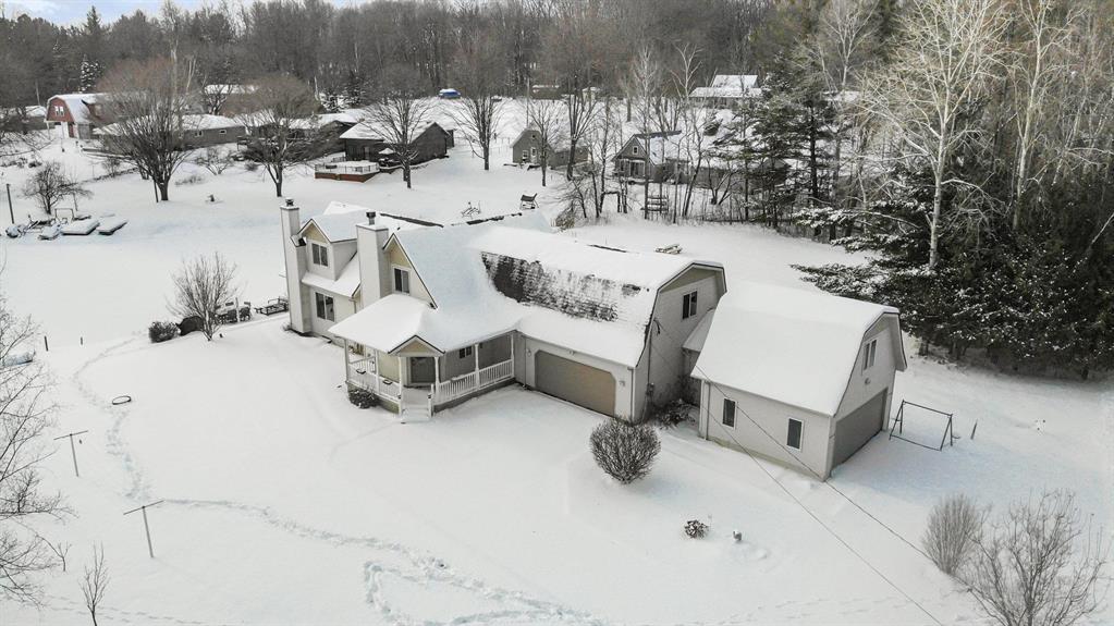 Welcome to your lakeside sanctuary at Five Lakes in Clare County! This stunning 5-bedroom, 3-bathroom oasis offers the perfect blend of comfort and style amidst breathtaking natural beauty featuring three lots, one across the road and two waterfront lot. Just 4 miles off US 127, this spacious retreat is easily accessible, yet offers a serene escape from the everyday hustle. Step inside to find a bright, open layout accentuated by large windows that flood the home with natural light and offer picturesque views of the surrounding lush greenery. The expansive living room, complete with a cozy fireplace, invites you to unwind and soak in the tranquil environment. The modern kitchen boasts stainless steel appliances and ample dining space, perfect for hosting and entertaining. Relax on the charming covered porch and enjoy serene water views or explore your own sandy beach, with private dock access providing endless opportunities for water activities. Abundant storage assures plenty of room for kayaks, boats, and more. Outdoors, delight in beautifully landscaped gardens, a patio ideal for dining alfresco, and a gentle breeze from the serene lake. blacktop roads, natural gas service, new roof July 2025 and thoughtful renovations complete this captivating package. Whether you seek adventure or peace, this property offers the best of both worlds. Make this your dream retreat today!