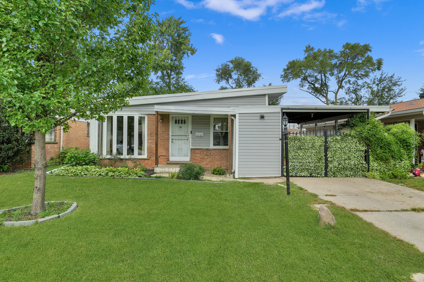 Located in a highly desirable neighborhood, this charming three-bedroom, one-bath home offers comfortable and convenient living. The home has modern flooring throughout, creating a warm and welcoming ready-to-move-in feel. The functional layout provides a bright space perfect for daily life. Exterior features include the added convenience of a covered carport and an oversized, detached two-car garage, offering excellent shelter and plenty of extra storage space.