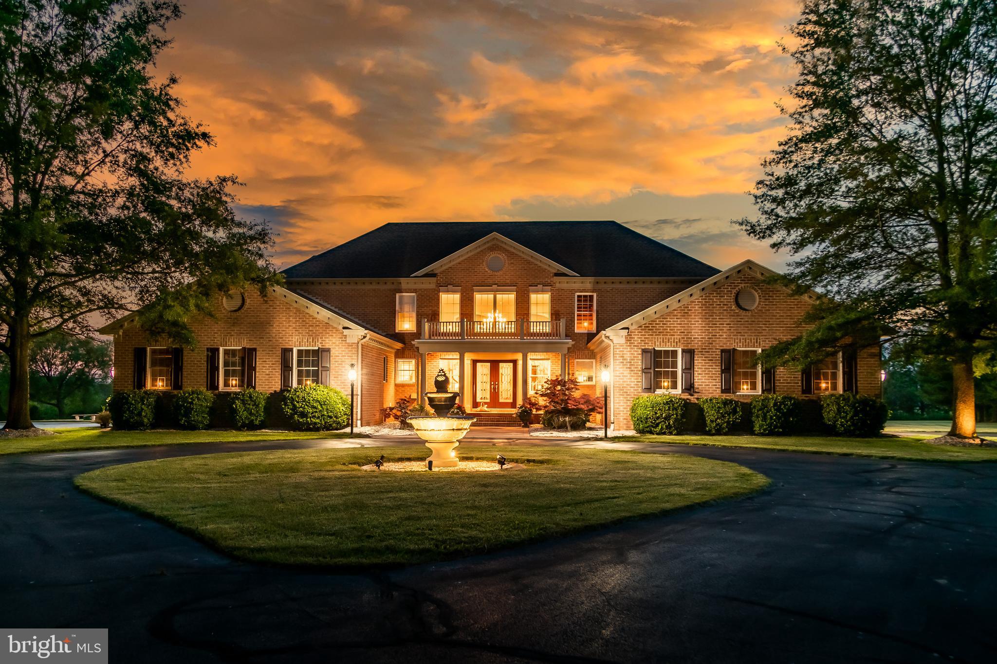 Welcome to 12661 Mallard Lane – A One-of-a-Kind Home in Covington Cove. Discover unparalleled charm and elegance in this stunning 3,104 sq ft home. From the moment you turn onto Mallard Lane, this property makes a lasting impression with its show-stopping curb appeal—featuring a circular driveway adorned with a pineapple water fountain, mature trees lining the entrance, a welcoming front porch, and elegant outdoor lighting that highlights every detail. Step inside through double glass doors to a breathtaking foyer showcasing dual grand staircases with classic wainscoting and a sparkling crystal chandelier, complete with bell-shaped crystals that ring. A motorized lift makes maintaining this centerpiece both easy and safe. Beyond the entrance, the family room opens up with a soaring vaulted ceiling, a see-through brick fireplace, and dramatic two-story arched windows that flood the space with natural light and offer spectacular sunset views. Beautiful hardwood flooring flows seamlessly into the formal dining room and into a thoughtfully designed kitchen that’s both stunning and highly functional. The custom kitchen features hand-built birch cabinetry, striking blue opal granite countertops, a spacious center island, and ample soft-close cabinetry for all your storage needs. Stainless steel appliances—including a new refrigerator, microwave, and wall oven—round out this impressive space. Enjoy casual dining in the cozy breakfast nook, where panoramic views of the lush backyard  and Monie Creek make every meal feel special. Just off the kitchen, the utility room offers practical storage solutions, including tall cabinetry perfect for cleaning supplies and tools as well as access to the attached two car garage. Every inch of this home was designed with convenience and comfort in mind. The main level also includes a private in-law suite—complete with its own attached garage, living room, kitchenette, bedroom, and full bathroom—ideal for extended family or guests. An additional bedroom, currently used as an office, and a half bath are also located on the first floor. Upstairs, enjoy sweeping views from the interior balcony that overlooks the family room and arched windows. On either end of the second floor, you'll find two spacious primary suites, each with its own walk-in closet and full ensuite bath. One of the suites features a serene sitting area with incredible views and a spa-like 4-piece bath with a whirlpool tub (heated by a Rinnai tankless water heater), and dual vanities. Storage is abundant, with three separate attic spaces—including one with a walk-up staircase to a fully floored third level, ready for finishing or organized storage. Finish your tour by relaxing on the screened-in side porch or back deck—perfect for morning coffee or summer crab feasts with loved ones. Boaters will especially appreciate the private, gated neighborhood boat ramp with direct access to Monie Creek for crabbing, fishing, and more. Don’t miss this rare opportunity to own a truly unique and thoughtfully designed home. Schedule your private showing today!