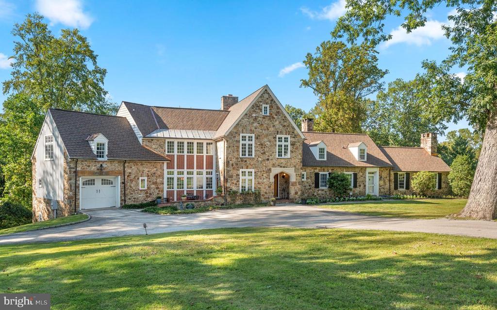Welcome to 659 Andover Road, a truly exceptional property. This handsome stone manor home immediately captivates with its breathtaking curb appeal and is nestled on 3.15 acres in the premier estate section of Newtown Square. Here you are just steps from Aronimink Golf Club & Episcopal Academy, and 5 minutes to downtown Wayne & the Newtown Town Center. This expansive Archer & Buchanan designed home boasts 6 Bedrooms, 4 Full, 3 Half Baths, and 6,350 sq. ft. above grade and 9,975 sq.ft. total including the finished lower level. As you approach the majestic front door, take note of the NEW CertainTeeds’s Grand Manor architectural shingle roof with copper flashing that was just installed this summer! Step into the elegant family room which serves as the heart of the home with timeless coffered ceilings and floor to ceiling French doors that flank the show- stopping fireplace. This room flows effortlessly into a spacious kitchen which has been tastefully updated in 2025 with quartz counter tops & backsplash, lighting fixtures, high-end appliances, and freshly painted custom cabinetry. French doors in the kitchen lead to a massive deck, built in 2020, which offers a covered outdoor space complete with a gas fireplace and an inground pool, creating an ideal setting for outdoor entertaining. Through another set of French doors is the expansive yet intimate dining room.  Continuing through the home, the gorgeous hardwood floors lead to a light-filled office as well as a home library with custom-built cabinetry, both spaces provide the perfect tranquil setting for privacy & focus. An additional front door entrance allows for separate access for professional use if so desired and is adjacent to the office & library as well as the back staircase. Completing the first floor is the star of the home; an extensive vaulted-ceiling pub/game room, offering versatile space that oozes with character and charm.  The main staircase ascends to the spectacular primary bedroom, which showcases a true sanctuary, boasting vaulted ceilings, a stunning array of windows, sitting area, two spacious outfitted walk-in closets and a luxurious en-suite bath with dual vanities, jetted tub, and an oversized walk-in shower. On the same level, there are four additional bedrooms and two bathrooms. The third floor offers a sixth bedroom with its own bathroom, providing a beautiful private suite perfect for visiting guests or an au-pair. The fully finished lower level of the home includes convenient access to the additional two rear garage bays, with back stairs leading directly into the mudroom. This walkout lower level features a large family room ideal for movies and games, a kitchenette, bonus room and a home gym. With neighboring properties selling up into the $3M+ price range, you don't want to miss this opportunity to call 659 Andover Road your home.