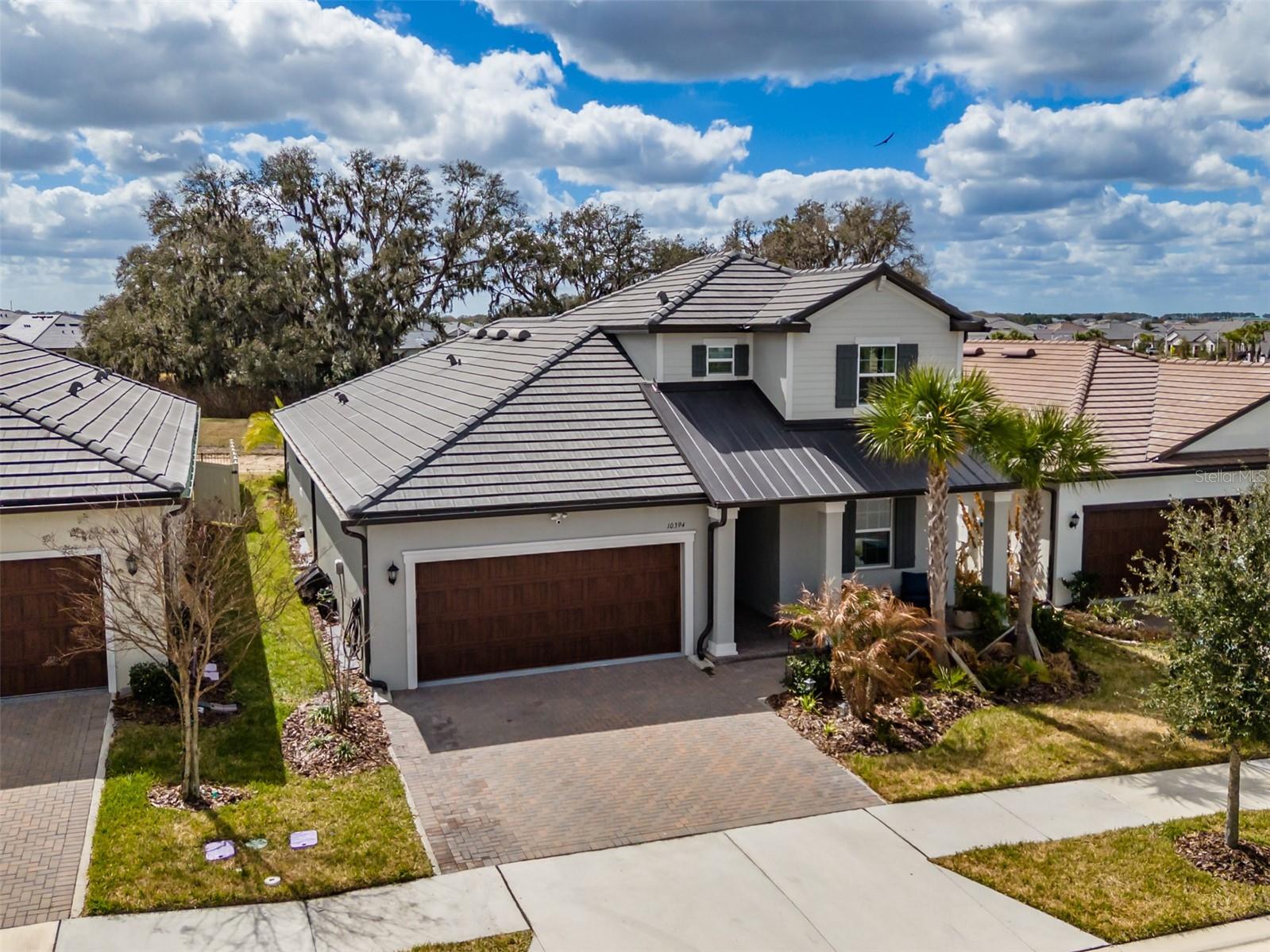 Serene pond setting, 3-bedroom, 3 full bath, 2366 sq ft, 2023 built 2 story Meridian II model located in the 55+ Medley At Mirada community, offers an open concept kitchen, dining room and Family room that overlooks the screened Lanai and pond. Quartz countertops are throughout. The owner’s suite is located on the first floor, with an ensuite bathroom featuring double sinks with a  private water closet, shower, and a large walk-in closet. The second bedroom, Flex room and Full Bathroom are also on the Ceramic Plank Tiled first floor along with a 3-car tandem garage with over 200 sq. ft. overhead storage. The second floor boasts a large, carpeted loft area and third bedroom and bathroom. The perfect place for family and friends to stay while visiting. All bedrooms, loft, Family room, Flex room, and Lanai  have ceiling fans. High speed fiber optic internet (ULTRAFI) & Spectrum cable TV is included in the HOA fee. Residents of Medley At Mirada have access to the resort style heated pool and amenity center equipped with café & bar, billiards room, card room, ballroom, 24 hr. fitness center, Sports courts featuring, tennis, pickleball, shuffleboard & bocce ball along with a tot lot and a dog park. There are many clubs, activities, and events for fun and enjoyment. In the heart of Mirada is the 15-acre Crystal Lagoon. The largest man-made Lagoon in the nation. Enjoy the crystal-clear blue water with a swim up bar, sandy beaches, cabanas, water slide, water splash zone, kayaking, water obstacle course. The Lagoon offers numerous activities  and entertainment for year-round enjoyment. This golf cart inspired community has a Publix shopping center at its entrance and is near Dade City, The Shops at Wiregrass and Tampa Premium outlet malls, The Grove, Golf courses, Bay Care and Advent Hospitals, with close proximity and easy access to Interstate 75.   CDD IS ALREADY INCLUDED IN TAX AMOUNT