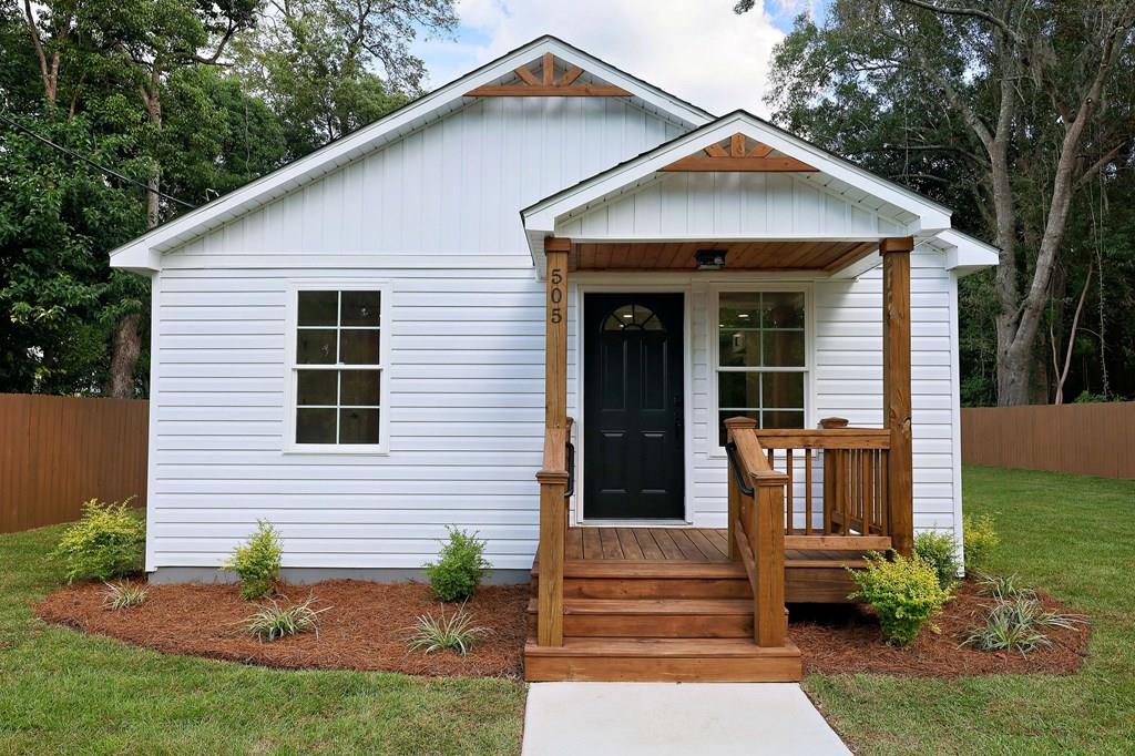 The perfect Thomasville cottage awaits! Located on a 1/4 acre lot, the newly constructed home offers an open-concept layout that is perfect for modern living. The home includes warm luxury plank flooring, shaker kitchen cabinets, granite countertops, stainless steel appliances & laundry closet. The bath adds that spa-like feeling with tiled shower & granite vanity. Outside, enjoy the deck & private backyard, ideal for unwinding & entertaining. Concrete drive, newly landscaped & fenced yard add that perfect curb appeal! You are minutes from downtown Thomasville  close to all medical facilities & schools.  Move-in ready and waiting for you! Come see it before it's gone!