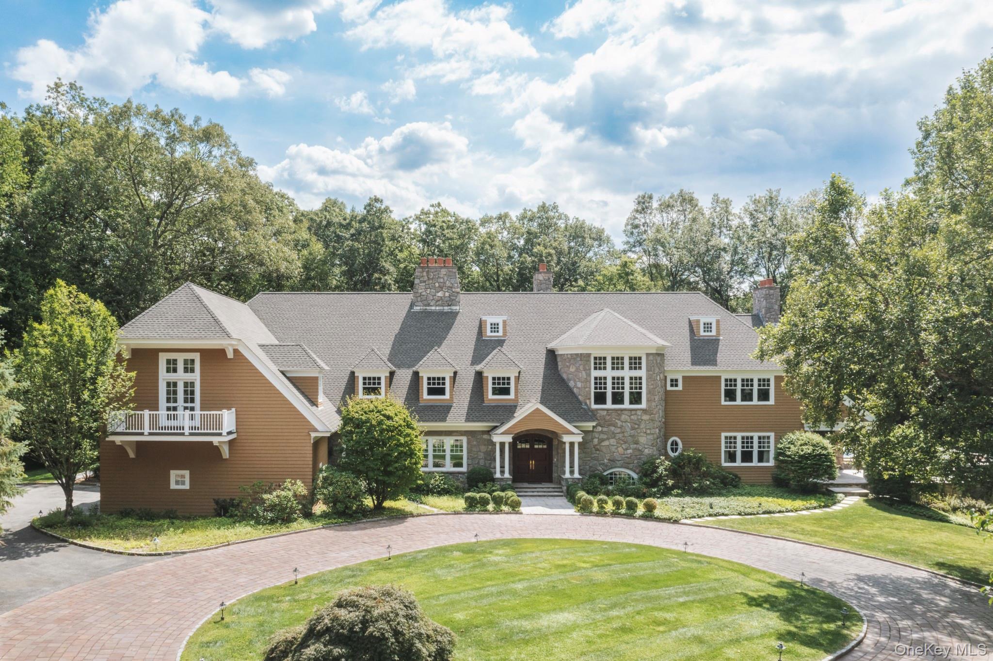 Just one hour from Manhattan, this extraordinary Bedford Corners estate offers the ultimate in privacy, scale, and resort-style living. Encompassing 14,000 square feet of custom design on 11.27 gated acres, the residence combines timeless sophistication with every modern amenity. Perfect for either a primary or weekend residence.

 A Retreat for Living, Working and Entertaining

The grand entry opens to sunlit living spaces and a dramatic 20-foot ceiling family room, anchored by a soaring floor-to-ceiling stone wood burning fireplace. Expansive entertaining rooms flow seamlessly to outdoor terraces and landscaped grounds. A grand formal dining room accompanied by a newly renovated chef’s kitchen sets the stage for both intimate dining and large-scale entertaining. For work or study, a distinguished office /library, richly finished in teak wood, with a wood burning fireplace provides a warm and refined setting - ideal for remote work, private meetings or quiet reading.

 Luxurious Private Quarters

The residence features six bedrooms, including a serene primary suite with a wood burning fireplace, private sitting room, enclosed porch, and dual custom dressing rooms. Two bedrooms are located on the main level for flexibility, while the upper level offers four additional bedrooms plus a bonus media/theater room. An elevator services all floors for effortless convenience.

Resort-Style Amenities

Designed for year-round enjoyment, the estate offers an unmatched collection of amenities:

Outdoor pool & spa with expansive stone terraces
Air-conditioned pool house with full kitchen and bath
Indoor swimming pool & spa for four-season use
Australian classic clay tennis court for the avid player
Gated entry for privacy and security
Custom windows & doors and plenty of closets and storage space.
 
Recent Enhancements

The property has been meticulously updated with a new roof, modernized mechanical systems, freshly painted and a renovated kitchen, ensuring turnkey comfort.

An Exceptional Offering

Perfectly blending country serenity with proximity to New York City, this Bedford Corners estate delivers a rare opportunity: a private compound with resort-level amenities just minutes from both the charming village of Bedford & the city of Mount Kisco with shopping, restaurants and a hospital. Private resort style living less than a one hour commute to Manhattan.