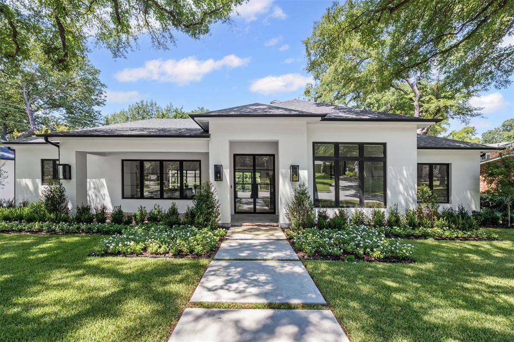 Welcome to this fully renovated modern ranch in the heart of Overton Park!! Thoughtfully redesigned with clean lines and contemporary details, this single-level home blends timeless design with today’s modern needs. Inside, soaring 11+ foot ceilings and expansive steel windows create a light-filled, airy atmosphere. Sleek white walls pair beautifully with wide-plank white oak flooring, setting the stage for a refined yet inviting home. The open layout seamlessly connects the living, dining, and kitchen spaces—perfect for both everyday living and entertaining. The chef’s kitchen has a gas range, custom cabinetry, large island, and scullery with beverage and storage. The outdoor covered patio features a high-pitched cedar ceiling and massive gas fireplace, creating the perfect place for grilling or quietly unwinding after your workday.  The private grounds are sprinkled with mature trees and professionally landscaping with room for a pool, if desired. Fully permitted and renovated to the studs - exceptional upgrades include all new plumbing, electrical, spray foam insulation and tankless water heater. A breezeway attaches an oversized 2-car garage outfitted with plumbing, HVAC, and private entrance creating an ideal opportunity to convert into a private guest house, office, or studio. Just a short walk to Overton Park, this is zoned in the highly acclaimed Overton Park Elementary, and offers both luxury and convenience in one of Fort Worth’s most sought-after communities.