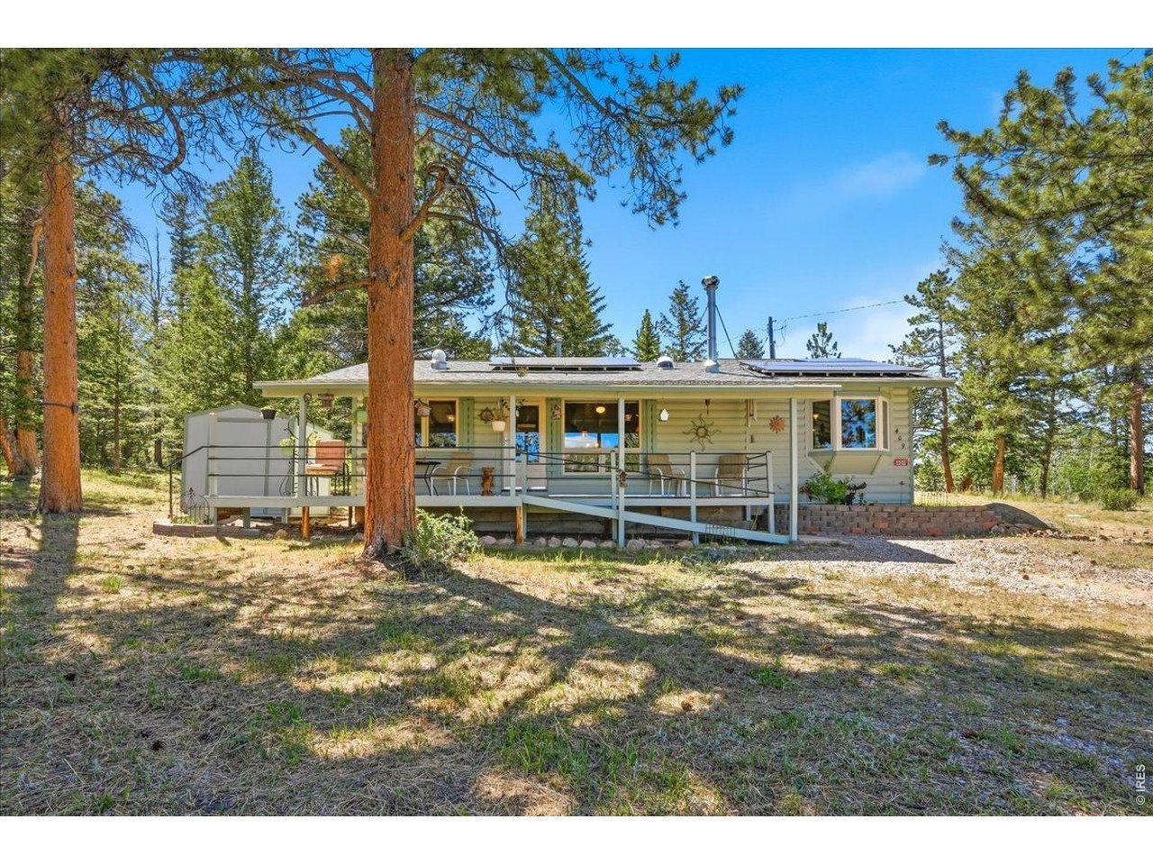 What a find! You're invited to visit this beautifully maintained log sided cabin tucked away in the scenic mountains of Northern Colorado. Ideally situated in the charming fishing village of Red Feather Lakes. Step inside to discover a spacious kitchen featuring a massive island, ideal for preparing meals and entertaining guests. The adjacent dining room, with its bay windows, provides beautiful views overlooking peaceful Shagwa Lake. The cabin features Pella windows and doors, original wood cookstove, on demand hot water, two comfortable bedrooms and a 3/4 bathroom, along with a cozy living room that invites you to sit in front of the fire on chilly evenings. Set on a generous half-acre lot, the property offers privacy and tranquility in a lovely natural setting. Modern amenities include a solar system for sustainable energy, a private well, and a full updated septic system. With no HOA restrictions, you'll enjoy the freedom to make the space truly your own. The quiet neighborhood adds to the serene atmosphere, and for those who love to fish, a private fishing membership is available-perfect for taking advantage of the area's renowned lakes and streams. This home truly has it all, combining mountain charm with practical features to create an ideal retreat or year-round residence.
