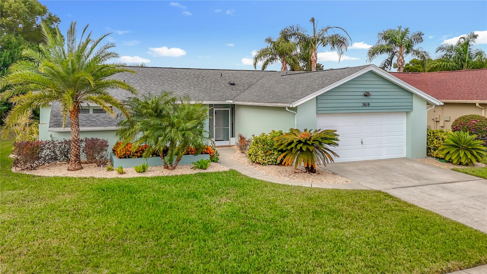 Get ready to enjoy the Florida lifestyle in a home that feels like new! Beautiful, split open floor plan home is not only light and airy, but very well designed. This 2/2 home with bonus den/room that features built in shelving (which can easily be converted to a 3rd bedroom) has high ceilings, matching tile flooring throughout, and a wonderful kitchen any chef would love to entertain in. Solid wood cabinets, a dining room area featuring bay windows, beautiful stainless steel appliances, and granite counters add a touch of luxury to the kitchen. Central, large living room features a real wood-burning fireplace. The huge primary bedroom features double walk in closets, an en-suite double sink bathroom with lots of storage space, and sliding glass doors to the back lanai. The second large bedroom on the opposite side of the home features a huge double closet! Enjoy your privacy! You'll love entertaining and relaxing with beautifully landscaped views when you step out of the triple sliding-glass doors to your enclosed and screened in, oversized back patio lanai with walk in storage that offers plenty of privacy! Awesome ceiling fans and lights throughout to keep you nice and cool. There's plenty of room for storage in the oversized 2-car garage. Time to have fun? Hit the community clubhouse or pool to cool off and relax! Located in a highly rated school district in the established and desirable community of Fairway Springs near Trinity, you will be so close to all you need: shopping, top-rated hospitals and schools, parks, fine dining, entertainment, historic downtown New Port Richey, award-winning beaches, and the highway to Tampa. Wonderful, peaceful, established fine community.Fresh paint inside and out 2024, A/C 2025, roof estimated 2020, sprinklers, partially fenced, super low HOA.