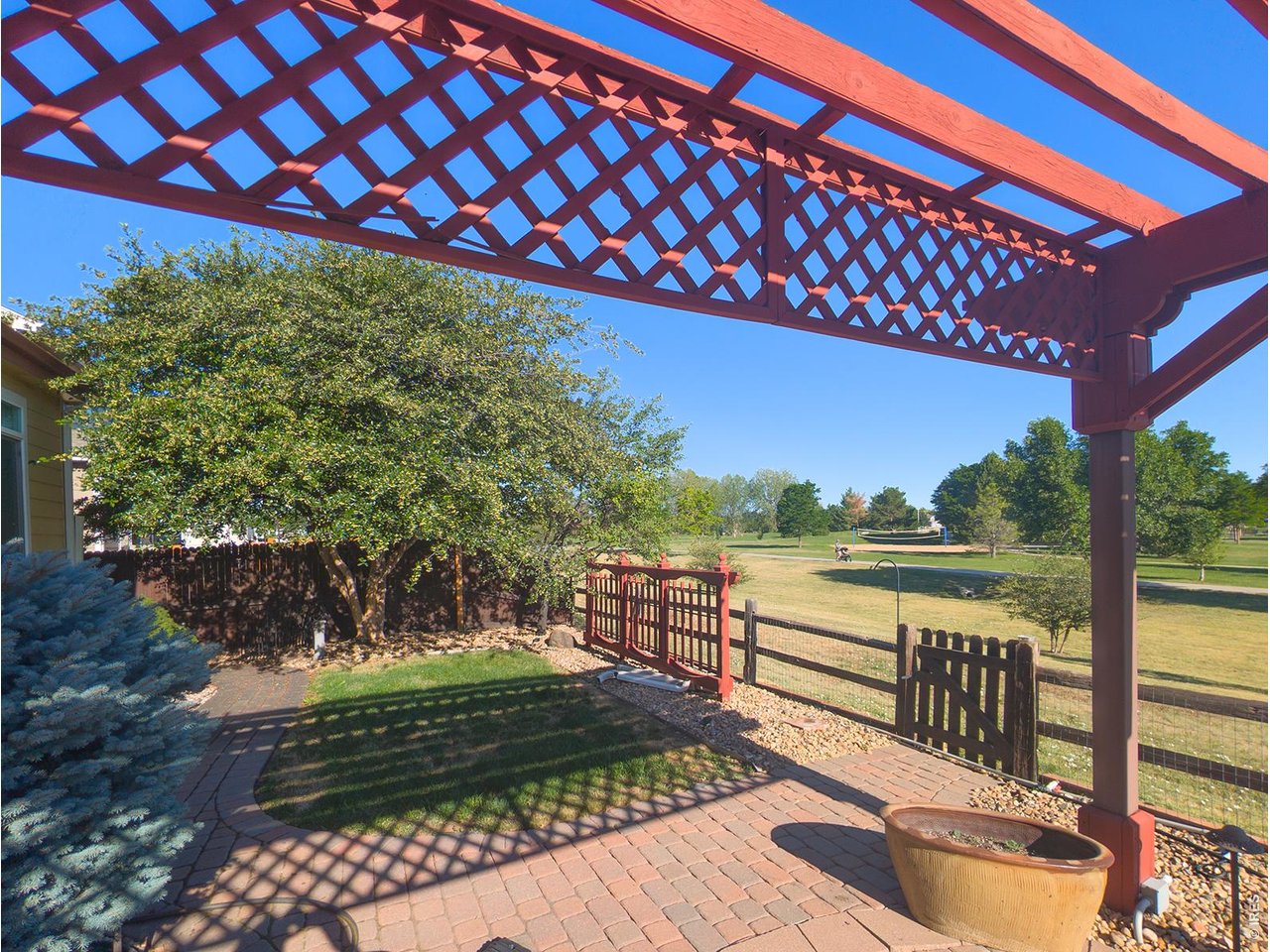 Opportunities for main floor living and the peace of backing to a large park are few and far between. Located in the sought-after Quail Crossing neighborhood, this upscale ranch style home built in 2001 backs directly to the greenery of the extensive Stephen Day Park. Featuring high vaulted ceilings and plantation shutters throughout the home, this open-concept floor plan connects the living room, family room, formal dining, kitchen, breakfast bar, and a eat-in dining area. There is extensive (real) hardwood flooring from the entry through the hallways to the kitchen and family room. With extensive cabinetry and counter space, this gourmet kitchen strikes a balance between functional efficiency and timeless style. Rich cherry cabinetry, premium granite countertops, stainless-steel appliances, and beautiful Italianate tile treatments bring an old-world charm to modern conveniences. With two living areas and a study framed by French doors, this beautiful home delivers plenty of living space, style, and flexibility; perfect for everyday living and entertaining. The generous primary is a peaceful retreat, with vaulted ceilings, plantation shutters, wide open views of the park, a walk-in closet and an ensuite bath. Tailor-made for relaxation, the family room centers around a custom fireplace surround that masterfully matches the home's interior aesthetic. Every corner reveals meticulous quality, showcasing high-end custom touches like crisp crown molding, tailored frame molding, and artisan tile accents. Outside, take in the mountain views and the natural beauty that makes Longmont living so special. Relax under the peaceful pergola. Enjoy the private patio, flower beds and direct access to the park. A property of this caliber rarely stays on the market for long. Contact us today to arrange a walkthrough!