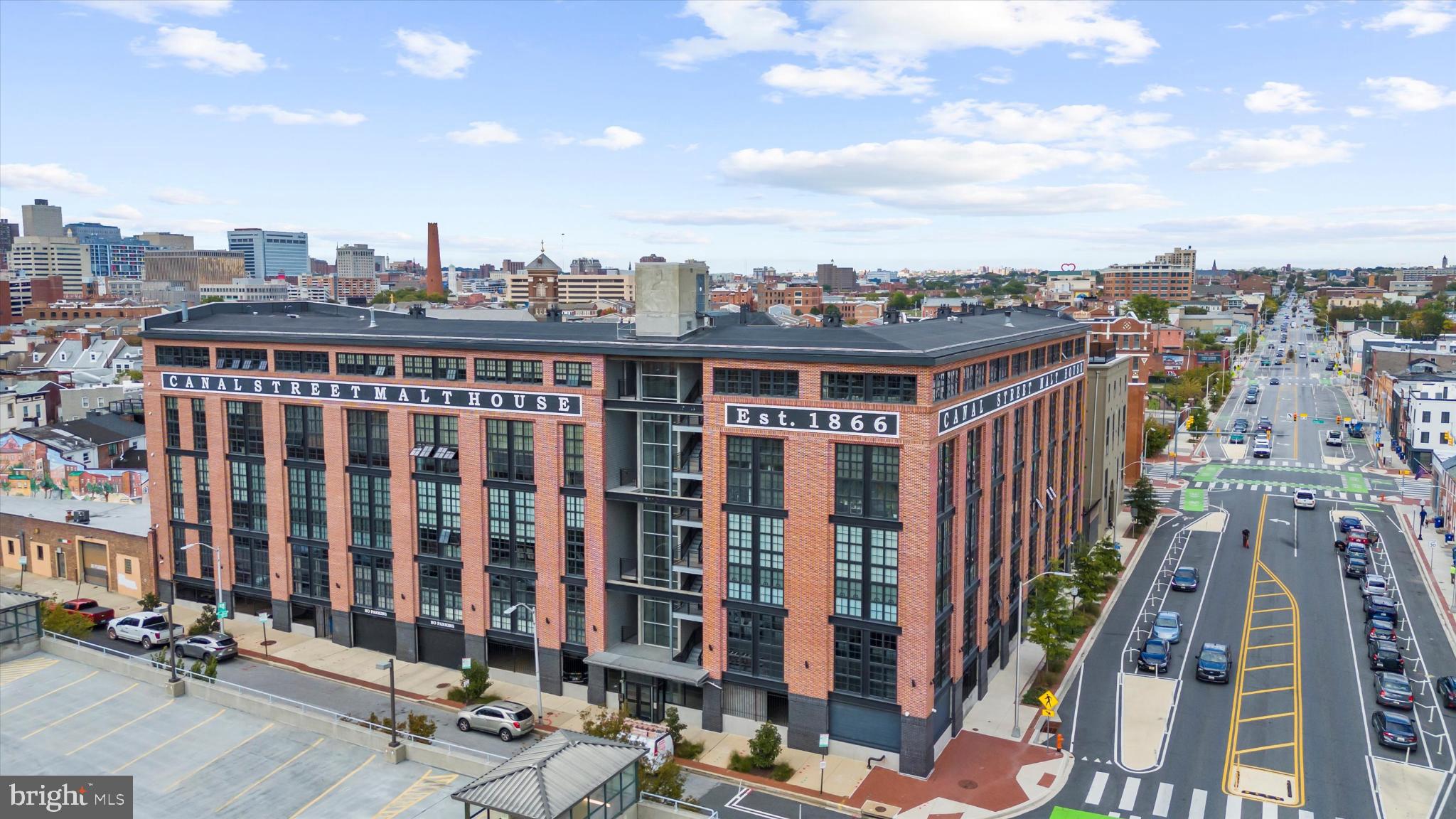 Truly extraordinary industrial loft condo located in the heart of Little Italy and steps away from neighboring Harbor East. Upon entering, the main level features a sprawling open floor plan, sleek concrete floors, exposed brick walls, exposed ducts, a beautiful staircase, and an abundance of storage. The combination living room and dining room space is perfect for entertaining and features a custom library wall. The gourmet galley kitchen features stainless steel appliances, a six-burner stove, and a wine refrigerator. A large laundry/utility room adds extra storage. A space off the kitchen provides a great space for casual dining. The main-level bedroom suite features a large walk-in closet, an additional walk-in storage room, and a full bathroom with a shower. The lofted primary suite occupies the entire second level and features a space for an office, fitness area, or reading nook, a walk-in closet, and a primary bathroom with a large soaking tub. The condo comes with one assigned garage parking space. Enjoy living steps away from the best restaurants in Little Italy, Harbor East, and Whole Foods. A central location makes walking to the Inner Harbor and Fells Point attractions easy as well as access to I83.