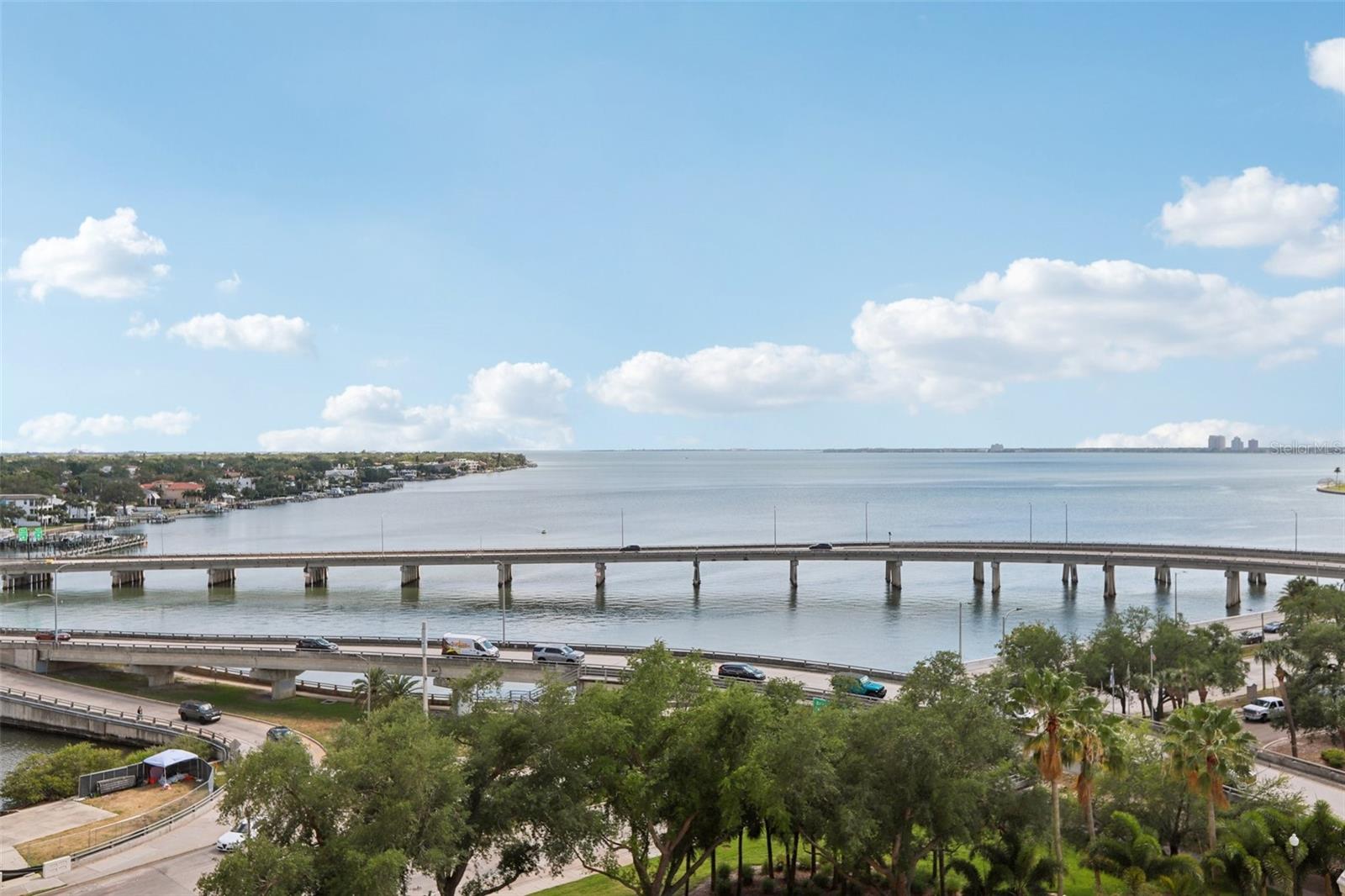 Experience elevated luxury on iconic Bayshore Boulevard! This meticulously maintained 9th-floor residence has been flawlessly renovated for the most discerning buyer, offering unobstructed views of Bayshore and Tampa Bay with spectacular sunsets from your private balcony. The interior features premium 12mm thick Nuvelle Aqua Safe waterproof laminate flooring throughout.The chef’s kitchen is a true masterpiece featuring a premium Taj Mahal quartz waterfall breakfast bar, farmhouse sink, and an elevated KitchenAid appliance package. This stunning Taj Mahal quartz is carried consistently through the kitchen, dry bar, and bathroom. High-end Emtek hardware is featured throughout. For the wellness-conscious, the home is pre-plumbed for a whole-house water filtration system.Perfectly designed for entertaining, the living area features floating shelves and a chic dry bar with a built-in wine cooler. The primary suite serves as a private retreat, featuring a premium custom Elfa shelving system and a spa-inspired bath with a double vanity and a frameless glass walk-in shower. For ultimate convenience, the bedroom and living room are equipped with custom, fully motorized, remote-controlled solar curtains. This home also includes an LG High Efficiency Smart washer and dryer and two assigned parking spaces.Take advantage of the building’s premier amenities: 24-hour concierge, library with a fireplace, residence lounge, two fitness centers, and a professional business center. Outdoor features include a heated pool, jacuzzi, grilling stations, and a pet walk. Boasting an exceptional walk score, this location is just minutes from the Tampa Riverwalk, Hyde Park Village, and the Tampa General Hospital expansion. A rare opportunity to own a flawlessly reimagined home in the heart of Tampa!
