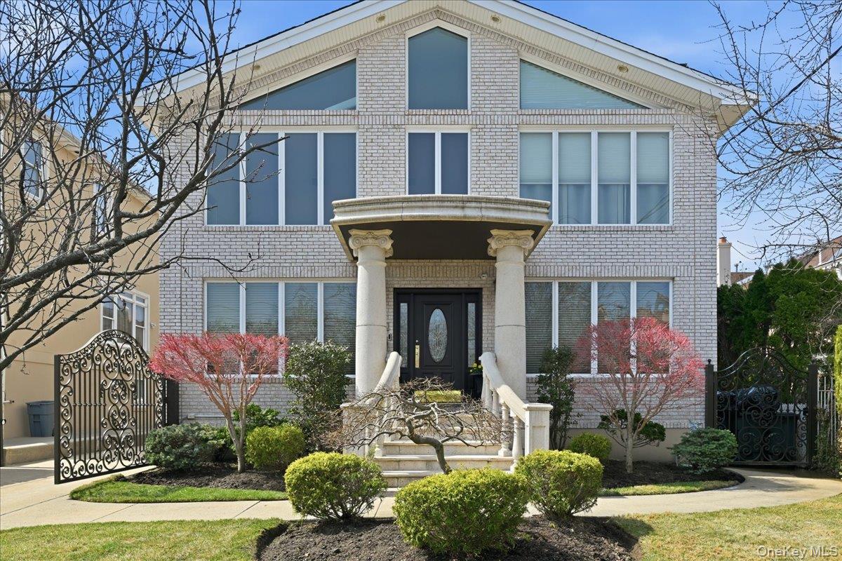 Welcome to this exceptional all-brick residence offering over 3,600+ sq ft of refined living space on an oversized lot (approx. 7,424 sq ft), ideally situated in one of Bayside’s most desirable neighborhoods.A dramatic two-story foyer with a sweeping spiral staircase sets a grand tone upon entry. The main level features formal living with a wood-burning fireplace, formal dining room, an expansive family room, and a beautifully appointed chef’s kitchen featuring a Viking 6-burner stove and double wall oven, designed for both everyday living and effortless entertaining. A full bathroom and first-floor office—easily convertible to a fifth bedroom—add flexibility.Sliding doors off the kitchen open to a private backyard oasis with a built-in heated saltwater pool, gas bbq & electric awning, creating seamless indoor-outdoor living.Upstairs, the spacious primary en-suite offers a skylit bathroom and two walk-in closets. Three additional bedrooms, a full bathroom, and a conveniently located second-floor laundry room complete the level.The full finished lower level with a separate outside entrance includes high ceilings, a dedicated gym with equipment included, oversized recreational space and a projector with movie screen for an at-home theater experience! Additional features include central air conditioning, Anderson windows, whole house generator and garage.Conveniently located near shopping, dining, parks, and transportation, including the LIRR Bayside station for an easy Manhattan commute.
