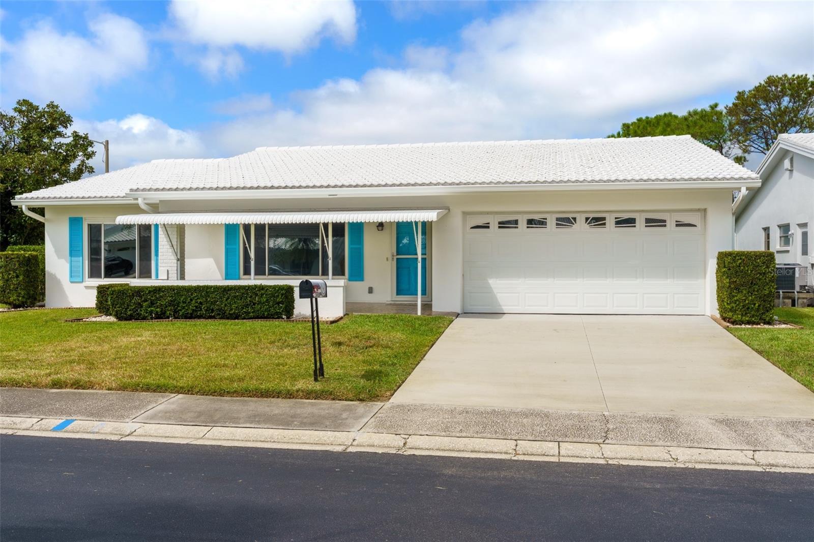 Move-in ready with major 4-point items already updated, including a 2020 roof, 2019 HVAC, 2019 water heater, 2014 electrical panel, and replaced HVAC ductwork. Enjoy water and golf course views from the bonus room in this corner-lot home. The open floor plan features gray wood-look plank ceramic tile throughout, an updated kitchen with granite countertops, updated cabinetry and 2020 appliances, plus a convenient pass-through to the Florida room.The primary suite offers a walk-in closet and en suite bath with step-in shower, vanity with granite countertop. The guest bedroom also has a walk-in closet, and the guest bath features a tub/shower combination with vanity and granite countertop. The versatile bonus room is perfectly positioned to enjoy the scenery and can serve as a dining area, home office, or additional living space. A covered porch provides another spot to relax and enjoy the surroundings.Monthly maintenance is just $415 and includes lawn care, exterior painting, water/sewer/trash, reclaimed-water irrigation, internet, and two digital cable boxes. Mainlands is an active 55+ community with a clubhouse, heated pool, shuffleboard and activities, surrounding an 18-hole public golf course and adjacent to Freedom Lake Park. Convenient to shopping, dining, medical facilities and more. Two pets permitted with no size restriction.