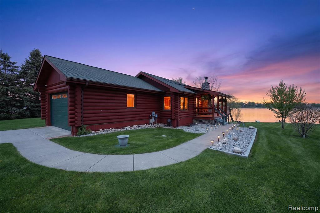 PRIVATE PENINSULA SETTING ON ALL-SPORTS PRIVATE LOCH ERIN WITH SUNRISE VIEWS THAT WILL STOP YOU IN YOUR TRACKS.Welcome to this rare lakefront opportunity tucked at the end of a quiet cul-de-sac on highly sought-after Loch Erin. Perfectly positioned on a private peninsula, this stunning log home sits elevated above the water, capturing panoramic views and unforgettable sunrises across one of Southeast Michigan’s most desirable all-sports lakes.Step inside to a bright, open-concept main level featuring cathedral ceilings, natural woodwork, and windows that flood the home with light while perfectly framing the lake. The spacious great room flows seamlessly into the kitchen and dining areas, creating an ideal setting for entertaining or simply relaxing and taking in the view.The main level has been thoughtfully updated with a brand-new walk-in shower. The finished walkout lower level offers additional living space and direct access to the patio, making indoor-outdoor living ideal for hosting guests or enjoying lake days.Outdoor features truly set this property apart:• Expansive wraparound deck spanning both the front and back of the home• Lower-level patio off walkout basement• Private beach area for swimming and lounging• Brand new dock ready for boating and lake toys• Elevated vantage point delivering stunning sunrise views over the waterWhether you’re enjoying peaceful mornings with coffee, entertaining on summer weekends, or embracing year-round lake life, this home delivers a lifestyle few properties can match.Additional highlights include:• 4 bedrooms, 2 full baths• Approximately 1,872 sq ft of finished living space• 2-car attached garage• Open floor plan with vaulted ceilings• Mostly furnished sale with detailed inclusions and exclusions listThis is not just a home, it’s a turnkey lakefront experience on private all-sports Loch Erin.Seller is a licensed agent in the state of Michigan.