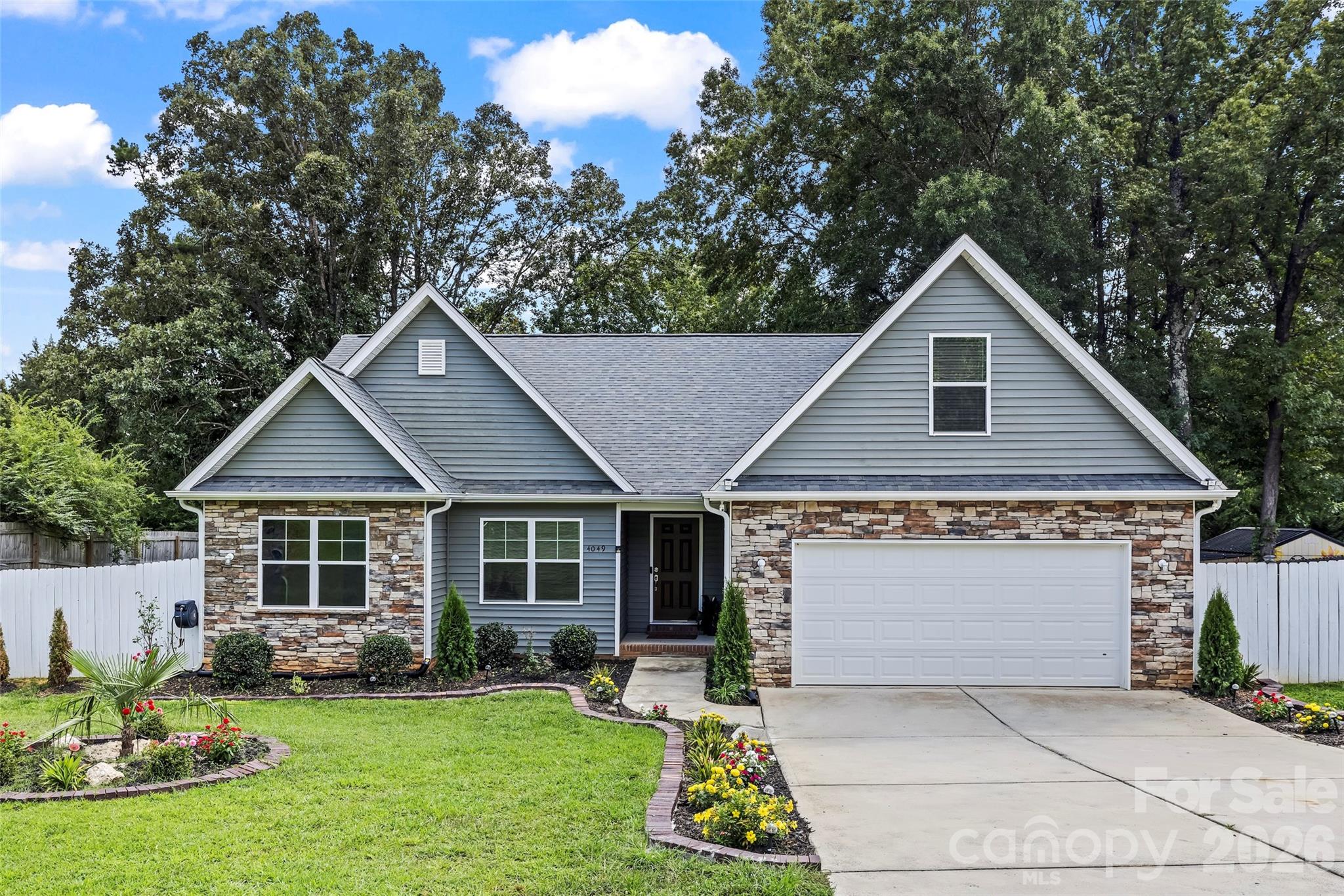 Welcome to this beautiful maintained 4 bedroom, 2 bath ranch-style home nestled on over half an acre in a prime location-minutes from Indian Trail, Matthews, Weddington, Wesley Chapel, and Waxhaw. This home features an open floor plan with a spacious living area, granite countertops, stainless steel appliances, and a breakfast bar in the kithchen. The primary suite boast a large walk-in closet and a private en suite with stunning  title shower. Enjoy outdoor entertaining with a large fenced-in backyard, covered patio, and a huge driveway with parking for  4+ vehicles. The landscape lighting at the front of the home, enhances the outdoor areas and adds curb appeal in the evening.