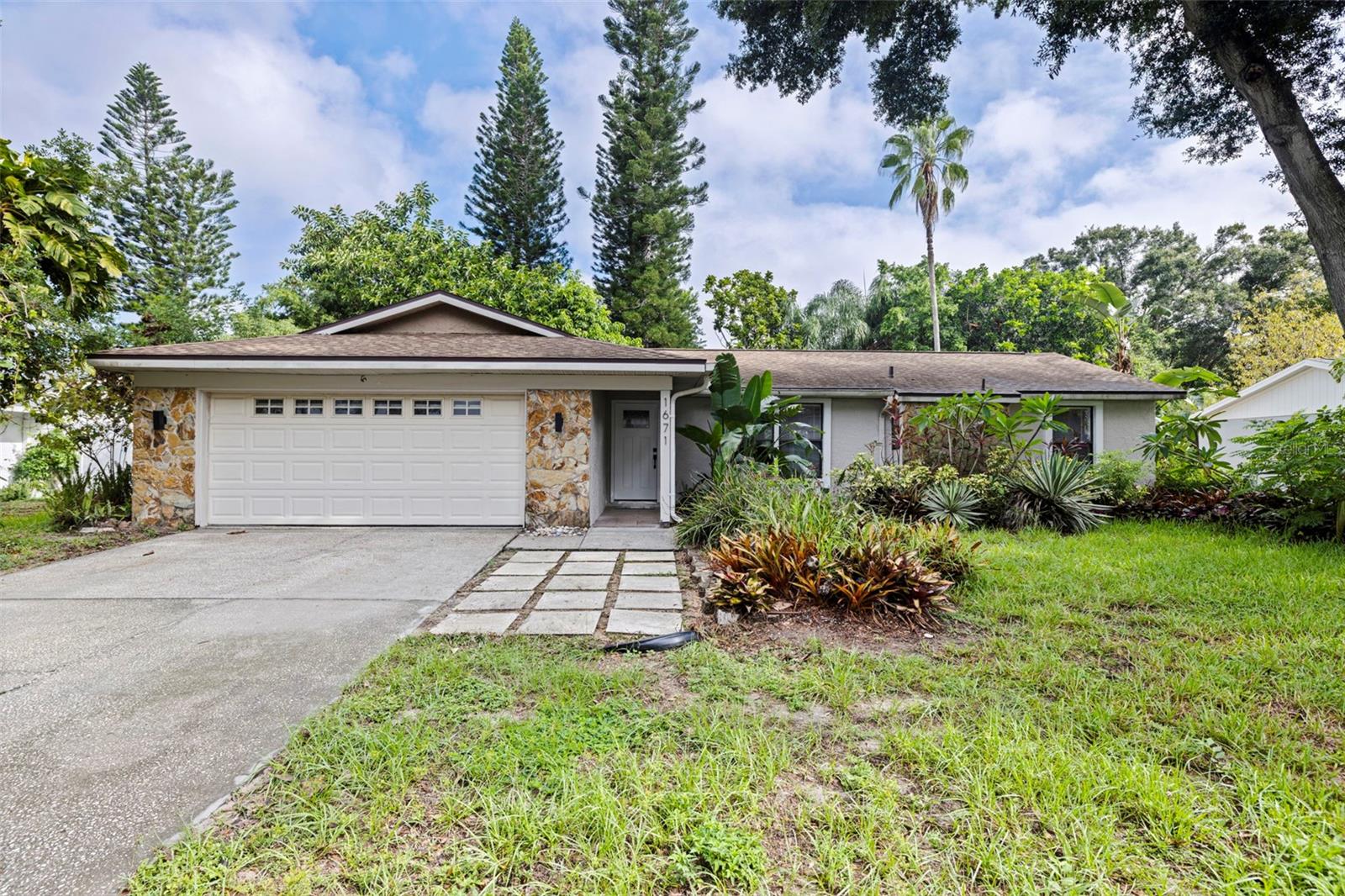 Welcome to this beautifully maintained 3-bedroom, 2-bath pool home in The Hammocks, one of Palm Harbor’s MOST desirable established communities. Surrounded by mature tropical landscaping, this inviting home offers bright and comfortable living spaces, abundant natural light, a formal dining room, elegant French doors, and a functional layout perfect for everyday living and entertaining. Step outside to your own private backyard retreat featuring a sparkling pool, spacious fenced yard, and lush landscaping with plenty of room to relax, entertain, or enjoy the Florida sunshine. Additional highlights include a two-car garage and a prime Palm Harbor location close to top-rated schools, Gulf beaches and Honeymoon Island, Downtown Dunedin and Safety Harbor, parks, trails, golf courses, shopping, dining, entertainment, and major commuter routes to Tampa and Clearwater. Offering the perfect combination of privacy, space, convenience, and community, this Palm Harbor pool home is ready to welcome its next owner.