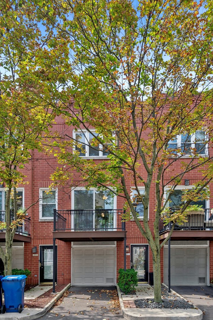 Gorgeous updated 3-bedroom, 2-bath townhome in the highly coveted gated Landmark Village community of West Lakeview/Roscoe Village, featuring one of the community's most desirable floor plans with a first-floor entry, attached garage plus exterior parking, and TWO private outdoor spaces! This sun-filled home offers east/west exposures, hardwood floors on the 2nd and 3rd levels, heated tile floors on the 1st level, and a skylight above the staircase. The first floor features direct garage access, a versatile 3rd bedroom/office/family room opening to a private terrace, and a beautifully remodeled full bath with marble tile and heated floors. The spacious 2nd level is perfect for entertaining with an updated kitchen featuring newer SS appliances, granite countertops, white cabinetry, beverage center, eat-in island, walk-in pantry and adjacent laundry. The dining area flows into the bright living room with a marble-tiled wood-burning fireplace, custom built-ins, and access to a large private deck with gas hookup. Upstairs are two generous bedrooms with professionally organized wall-to-wall closets and newer hardwood floors, plus a beautifully renovated shared bath with double vanity and glass-enclosed walk-in shower. Fantastic layout, abundant storage, two outdoor spaces and two parking spaces, all close to parks, grocery stores, dining, public transportation, the expressway, and everything Roscoe Village and West Lakeview have to offer!
