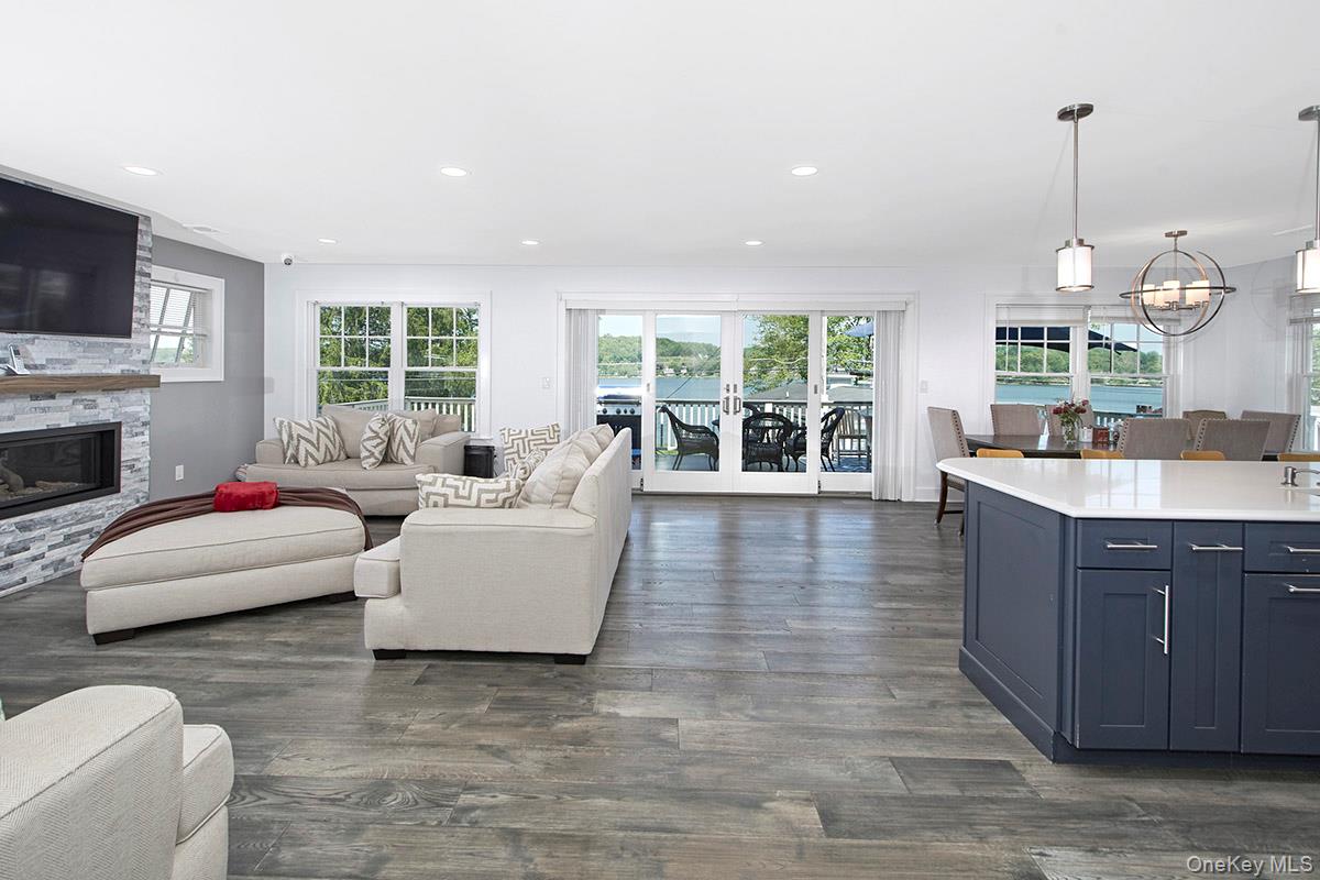 Welcome to a rare gem that seamlessly blends elegance, comfort, & the Lakeside lifestyle. This four-bedroom, four full bath 2018 contemporary ranch offers not just a home, but an unparalleled way of life with deeded lake rights to the highly sought after Peach Lake.  Step inside & be greeted by a light-filled main level with sliding glass door to the huge deck.  The living room, dining room, & kitchen connect seamlessly, creating an inviting and open space for entertaining with spectacular views of the lake.  The private primary suite occupies the second level, creating a tranquil retreat with its own luxurious spa-inspired bath, dressing area and a walk-in closet, this suite offers privacy & comfort.  The main level offers an additional primary bedroom with en-suite & walk-in closet, and two additional bedrooms that share a beautifully appointed hall bath. The fully finished walkout lower level adds even more versatility to this home, complete with a full bath, large rec room, gym area, laundry room, office, door to the oversized one-car garage and a full home generator.  From here, step outside to the backyard & follow the path to the lakefront, where you'll find a shared dock.  Lake activities are just steps away from boating, kayaking, fishing, paddleboarding and water skiing.  The neighborhood also offers a beach, clubhouse and golf.  Whether you’re seeking a full-time residence or a weekend retreat this home offers a perfect blend of convenience and relaxation.