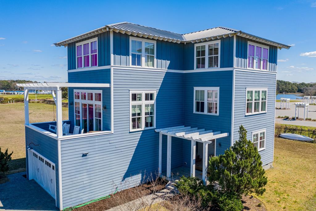 Experience refined coastal living in this custom 6-bed, 5-bath home with water views in a private gated community! Enjoy direct beach access, a community pool, and tennis/pickleball courts—great for both leisure and recreation. This fully furnished, high-performing vacation rental offers a strong income history. Inside, dual primary suites create serene escapes, while the chef's kitchen is set up for entertaining. Hardwood flooring and beautifully tiled baths enhance the elegant coastal vibe. Eligible for private club membership with access to a gym, additional pools, 27-hole golf course, private beach, trails, and the Coach House Tavern restaurant. Located near top community features and outdoor attractions such as the Oyster Farm Marina and wedding venue!