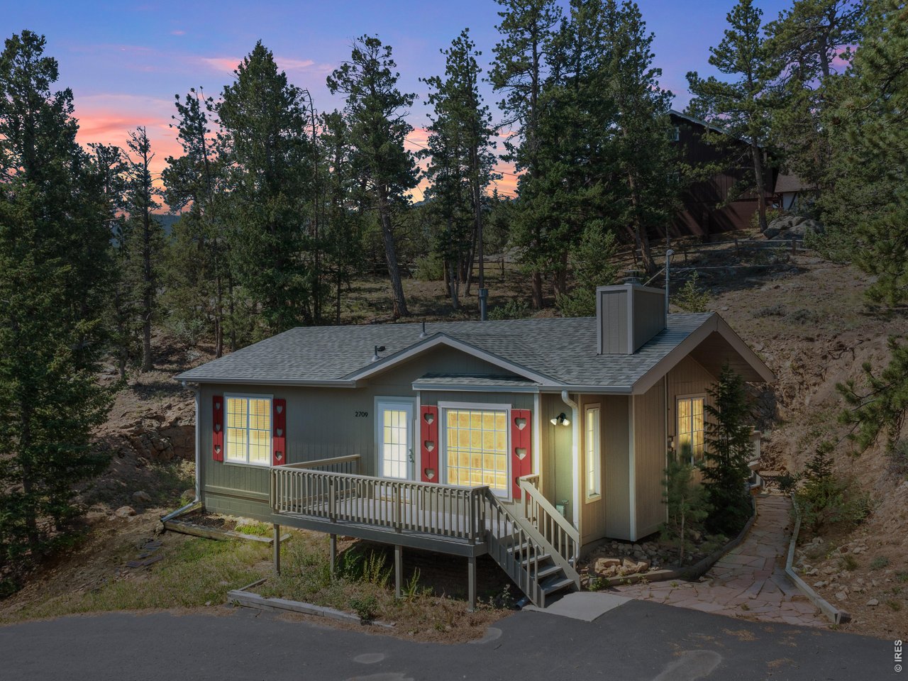 Tucked into Estes Park's desirable Carriage Hills area, this charming 2-bedroom, 2-bath home offers the ease of a smaller footprint without sacrificing comfort, character, or setting. 2709 Sunrise Ct features one level living, lots of windows, great views, and a spacious kitchen. Set at the end of a quiet cul-de-sac on a 1/2 acre lot, the home enjoys a peaceful setting with the kind of privacy and low-traffic feel buyers love, and it has big decks front and back. Thoughtfully laid out, the interior is warm and inviting with lots of sunlight, while the surrounding outdoor space gives you room to relax, entertain, and take in the beauty that makes Estes Park so special. Whether you're looking for a full-time residence, a weekend getaway, or a simpler mountain lifestyle, this beautiful, well cared for ranch gives you a chance to own a detached home in an established neighborhood close to town, trails, and stunning views of the Rocky Mountain National Park. Fish Creek Trail is just down the hill, and nat'l forest access is just up Little Valley. Come see this super cute home for yourself. Schedule a tour today!