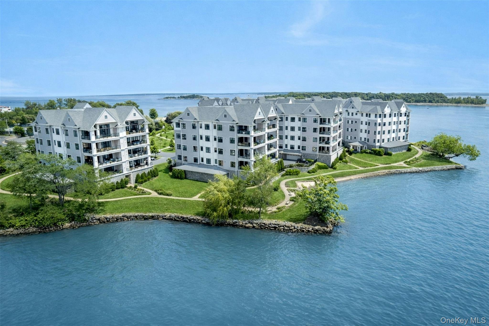 Welcome to the pinnacle of waterfront luxury living in this spectacular 2,717 SF 3-bedroom, 3.5 bathroom penthouse condo in New Rochelle with stunning water views from 3 sides, unique to this building. Upon entering, the home commands immediate attention with its magnificent 15' ceilings and an expansive open-concept layout that integrates the living, dining and kitchen areas into a fluid space anchored by a sleek electric fireplace.  The impressive chef's kitchen features high end appliances, quartz countertops, a huge island, lots of custom cabinetry and a walk-in pantry. The dramatic room transitions seamlessly to a large private balcony equipped with an electric barbecue for effortless grilling while watching the sun set over the water. The sophisticated private quarters are a masterclass in sanctuary design featuring a primary suite with 3 closets (2 walk-in) and a spa-like bathroom outfitted with a dual sink vanity, a deep soaking tub and a massive walk-in shower. Two additional bedrooms are generously proportioned with en-suite bathrooms. A chic powder room off the main living area, serves your guests. Daily convenience is elevated by an in-unit laundry room with lots of storage cabinetry. This pet friendly gated complex includes 2 indoor assigned parking spaces, a large temperature controlled storage room and a lifestyle that is truly exceptional. Vacation in your own home with resort style amenities including a heated outdoor pool, private beach, clubhouse with a party room, TV and fireplace, bar with a lounge, a state of the art fitness center and a kayaking facility, all strategically positioned to look directly over the glittering waters of the Long Island Sound.  There are 9 buildings and 72 units on 15 acres of well manicured property. Watermark Pointe is beautifully landscaped with an abundance of flowers, plantings and walking trails.  Only 35 minutes to NYC and a short ride to all airports, this dream home offers the life-style you have been waiting for.