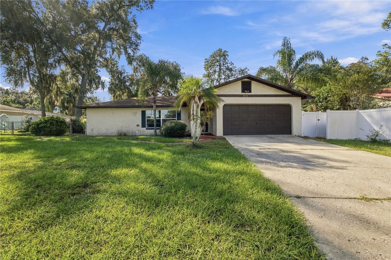Welcome to Plant City! This 3-bedroom, 2-bathroom home is full of potential, with many of the big-ticket updates already taken care of! Improvements include a new roof (2022), A/C (2023), septic system (2021), vinyl fencing (2025) and a newer water heater. Inside, you'll find a comfortable living area featuring a fireplace that adds warmth and character. The kitchen and dining area flow together, with French doors opening to the back porch, making it easy to enjoy indoor and outdoor living. Step outside to the spacious, fully fenced backyard with plenty of room for entertaining, gardening, pets or simply relaxing in the Florida sunshine. This home is in an X flood zone and NO HOA! Another great feature is the detached garage, offering endless possibilities as a workshop, hobby space, man cave, she-shed, or additional storage. While the interior is ready for some updating and your personal touches, the possibilities are easy to imagine! Conveniently located near shopping, dining, and I-4, with easy access to Tampa, Lakeland and of course the Florida Strawberry Festival! Bring your ideas and make this home your own. Schedule your showing today!