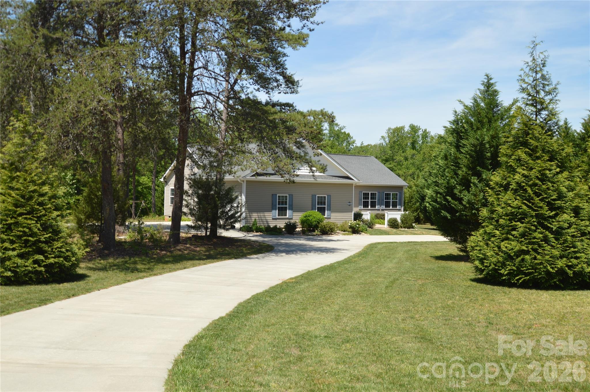Feel right at home and create your own mini farm!!!  Country living at it's best, offering a one owner, move in ready, much loved and well kept modular construction home with two stick built additions including the sunroom and spacious extended two car garage. The floorplan was designed with future handicap accessibility in mind. Other features of the home include spacious rooms with 9' ceilings, engineered hardwood flooring throughout, an attractive gas log fireplace and built ins in the living room, an open kitchen area with granite counter tops, mostly newer appliances and a built in breakfast nook.  Oversized bathrooms with luxury vinyl floors. A fabulous sunroom that opens to the pergola covered deck and a separate balcony exclusive to the Bull Frog hot tub that seats up to 6.  Low maintenance exterior, two hot water heaters, an encapsulated crawl space with dehumidifier and so much more! Matching the home is also an additional site built 24 X 24 two car garage that was added in 2020 that has enforced concrete for a lift and is wired for 220 plus a 30 X 16 steel and aluminum camper-port that is perfect for a motor home or horse trailer and also can fit two vehicles in tandem!  Extensive concrete driveway,  with an additional parking pad for two vehicles and stamped concrete front patio. Plenty of options for gardening, animals, and there is a small stream in the woods that appears to be spring fed! This is a great opportunity, don't miss out!