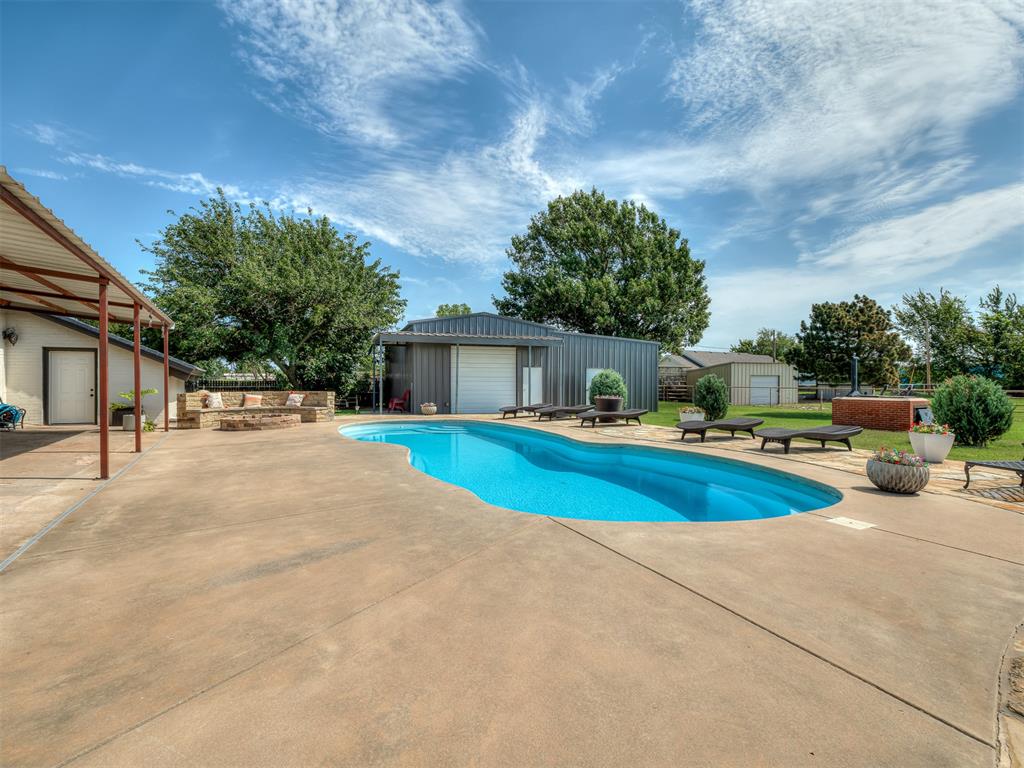 Properties with this level of character, functionality, amenities, and location rarely become available in Norman!Prime location on 2.2 acres! This unique 3 bedroom + loft, 2.5 bath home offers soaring wood-planked ceilings with exposed beams, and a stunning floor-to-ceiling stone wood-burning fireplace. The open-concept layout features a spacious kitchen with granite countertops, abundant cabinetry, stainless steel appliances, double ovens, and a large center island.Outside, enjoy your own private retreat with an inground pool, custom fire pit, insulated shop, horse stall barn, above-ground storm shelter, and wide-open space for hobbies, animals, and recreation. Additional upgrades include a premium Class 4 impact-resistant DaVinci roof installed two years ago and a whole-house water filtration and conditioning system.Acreage properties with this combination of location, amenities, and character are hard to find! Don't miss out!