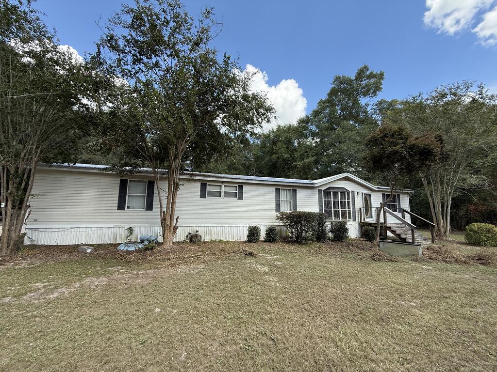 4 bedroom 2 1/2 bath mobile home on private partially wooded 2.82 acreage lot in the county. Centrally located between Cairo and Thomasville. Included carport with private deep well. Large storage shed with electric and manual  roll door. (Shop needs wood repairs) All appliances and TV's for cctv are included with sale of home. Don't miss out on this deal under 200K. No land restrictions.