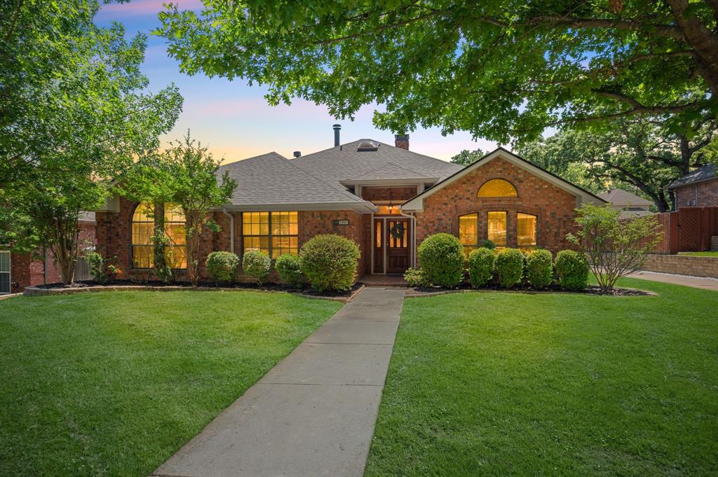You can’t beat this LOCATION! Nestled in the highly sought-after Yorkshire Meadows community, where homes rarely come on the market, this beautifully maintained single-story home offers a rare opportunity to own in a neighborhood that feeds into the exemplary Grapevine-Colleyville ISD and is within walking distance to all three top-rated schools. Step inside to discover a spacious layout featuring 3 bedrooms, 2.5 bathrooms, 2 living areas, a dedicated dining room, and a versatile flex space. Fresh carpet graces all bedrooms, while skylights and a double-sided gas fireplace between the living areas add warmth and charm. The kitchen is a chef’s dream with granite countertops, stainless steel appliances, a window overlooking the side yard, and a wet bar ideal for entertaining. A convenient half bath is tucked off the back family room—perfect for guests. The primary suite is a true sanctuary with vaulted ceilings, fresh paint, new carpet, and its own private fireplace. Just off the primary, a bonus room offers the perfect space for a home office, gym, or nursery. Outside, the private backyard is a tranquil retreat with lush landscaping, adorable storage shed, and an electric gate offering both security and ample parking for Texas-sized vehicles or even an RV.  The peaceful, one-way-in, one-way-out neighborhood includes a pocket park and fosters a serene, community feel. Major updates include a new roof (November 2024) and recently updated HVAC systems inside and out. The refrigerator, washer, and dryer will even convey with the home. Don’t miss your chance to own in one of the most desirable pockets of Grapevine. This home checks all the boxes for comfort, convenience, and community. Book a showing at your own risk—you will fall in LOVE!