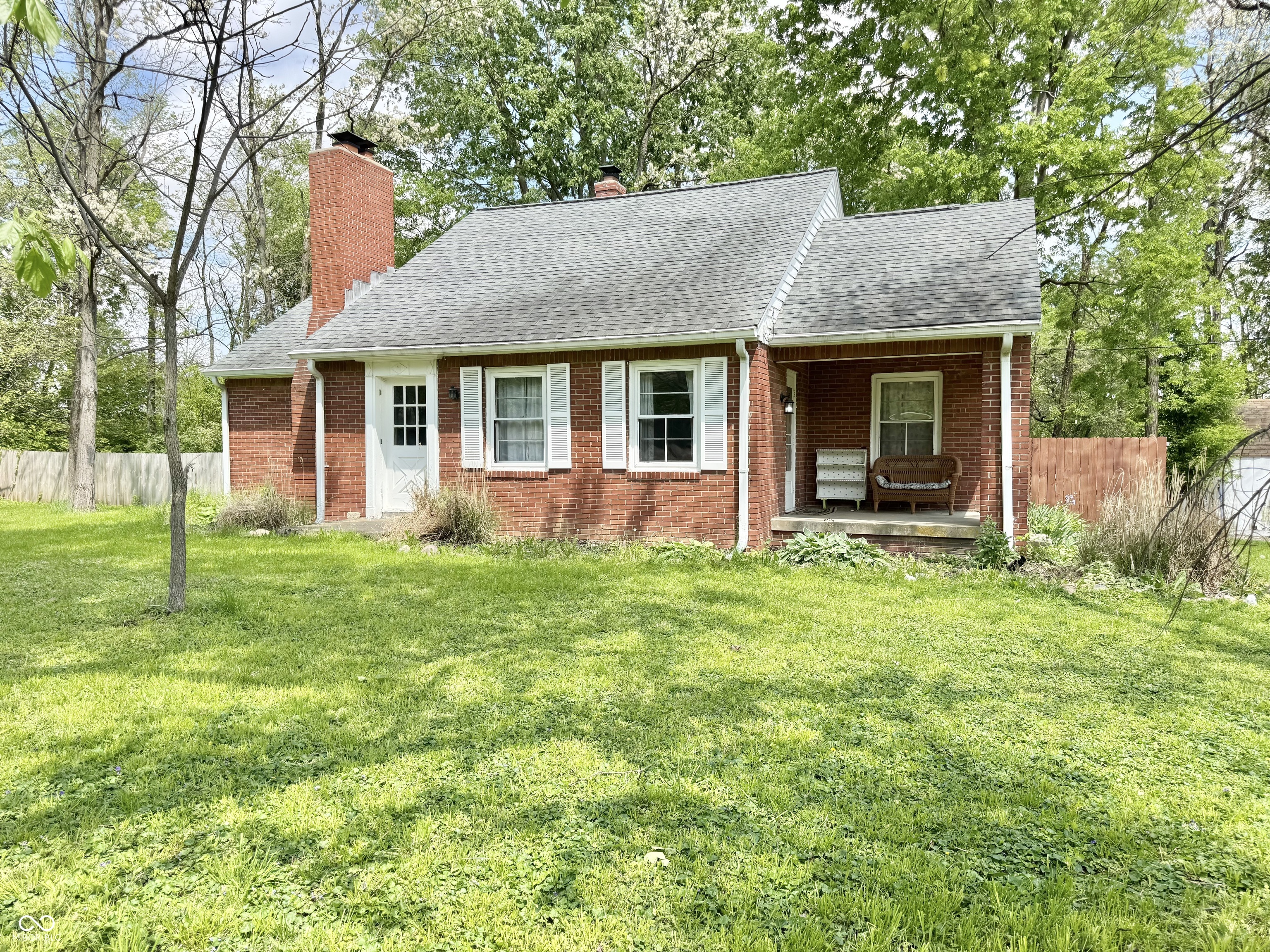 Charming 3-bedroom, 1.5-bath brick farmhouse offering timeless character with thoughtful updates, all just minutes from Zionsville amenities. Set on almost one acre, this fully fenced homestead features mature trees providing the perfect balance of sun and shade. Inside the home, you will find original hardwood floors, stunning stained glass doors, and solid masonry construction that speaks to the home's enduring quality.    Recent updates within the last 3 years include stainless steel appliances, HVAC system, bathroom renovations, and major pool improvements including a new liner, pump, and mechanicals. Enjoy year-round comfort with both modern HVAC and the option of an alternative heat source, a wood burning stove.    The full unfinished basement offers endless potential for storage or future living space. Outside, the inground pool creates the perfect setting for entertaining or relaxing in your private backyard retreat. The current owners have raised honey bees to produce local honey and free range chickens for fresh eggs.  A rare blend of classic farmhouse charm and modern convenience in a highly desirable location!