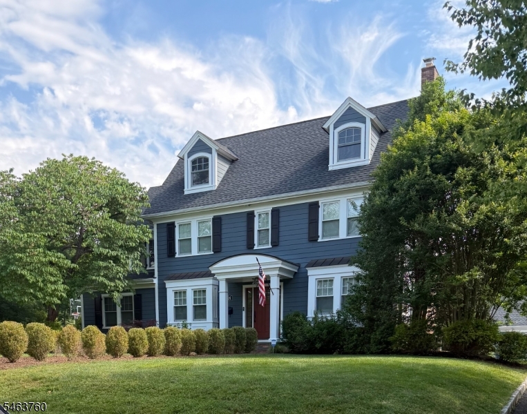 Center-hall colonial near downtown Westfield, renovated in 2025-26: all hardwood floors and stairs replaced with new wide-plank hardwood; new radon mitigation, water filtration and security systems; walls restored and repainted throughout. The work builds on a 2016 renovation with a three-story addition, a 2017 roof, fiber cement siding, Andersen windows and updated electrical, so the house is move-in ready. First floor: foyer; 23-foot living room with wood-burning fireplace, built-ins and box-beam ceiling; formal dining room; kitchen with large center island, stainless appliances including a built-in refrigerator, dry bar with wine refrigerator, pantry and banquette dining area; family room with gas fireplace; mudroom; powder room. Custom moldings and wainscoting. Second floor: primary suite with walk-in closet and full bath, three more bedrooms, two full baths and a laundry room. Third floor: bedroom suite with full bath and walk-in closet. Finished lower level with media, game and exercise areas, powder room and storage. Three-zone central air and multi-zone heat (steam, hot water, heat pump). Outside: level 0.28-acre lot, fenced rear yard with drainage, bluestone patio, in-ground sprinklers, exterior lighting and a detached 2-car garage. 0.1 mile to Wilson School, with downtown shops, dining, parks and the NJ Transit station close by.