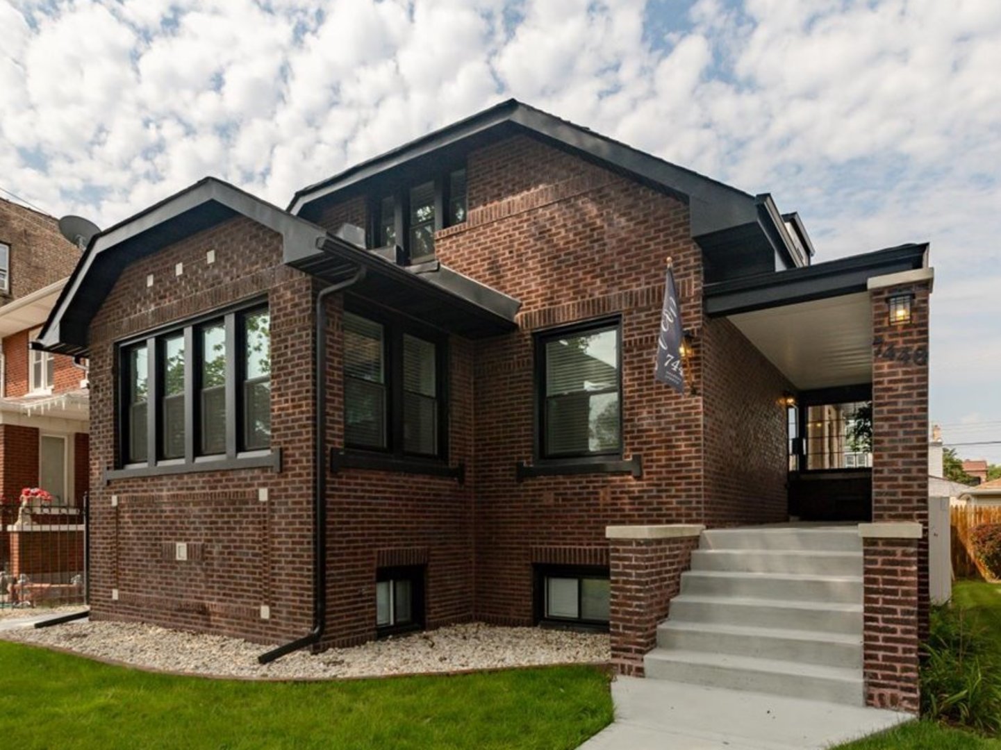 Luxury not often found at twice the price!  Welcome to 7440 South Oglesby Avenue, an extraordinary, masterfully reimagined brick bungalow nestled on a tranquil, tree-lined street. This remarkable residence, with its stunning blend of classic design and luxurious modern amenities, offers over 3,000 square feet of living space, five spacious bedrooms, and four spa-inspired bathrooms-perfect for a modern, sophisticated lifestyle. A Chef's Dream and Entertainer's Paradise. Step inside the light-filled main level and discover a seamless, open-concept floor plan. The living is highlighted by tall, 12-foot ceiling and an impressive chandelier, while brand-new, light oak floors flow throughout. A sleek focal point fireplace in the great room creates a cozy ambiance, and new thermal pane windows fill the entire home with natural light while keeping you comfy in the most extreme weather. The exceptional gourmet kitchen is a true culinary haven, boasting Silestone Miami White quartz waterfall counters and a matching full-height backsplash. Custom 42-inch luxury cabinets with additional 12-inch glass door cabinets extend to the ceiling, offering extensive storage. The magnificent 14-foot center island, with a Ruvati 45-inch workstation sink and seating for all your guest, is a functional and beautiful centerpiece. Culinary enthusiasts will love the premium 48-inch, 8-burner range, along with a French door refrigerator, stainless steel dishwasher, and Bosch built-in microwave. Entertaining is effortless with the convenient beverage station and with beverage fridge. A practical mudroom host a perfectly appointed laundry room, equipped with a Samsung front-loading washer and dryer, a utility sink, and custom cabinetry for optimal organization. The main level also includes a generously sized bedroom or home office and a stunning full bathroom with a rainfall spa shower panel and a full soaking tub. Luxurious Living Spaces on Every Level, a custom staircase with elegant glass panel railings leads to the upper level, where you'll find two private en-suite bedrooms, each designed as a serene retreat. These bedrooms feature ample closet and storage including a walk in in the primary bedroom, complemented by elegant, spa-inspired bathrooms. The fully finished lower level expands your living space with a recreation room, perfect for game nights. This level also includes two additional bedrooms, an exercise/multipurpose room, and another well-appointed full bathroom, making it ideal for extended family or hosting guests. The entire basement features new Duraflex natural wood-look vinyl flooring over newly poured concrete, and a 70-inch flat-screen TV is mounted on the family room wall. A Private Oasis and Prime Location. step outside to your private oasis, enclosed with a luxury privacy fence surrounding the oversized double lot. The beautifully landscaped yard features a spacious, new back deck, perfect for summer gatherings, and new sod and decorative river rock. A convenient underground sprinkler system effortlessly keeps the landscaping lush and vibrant. A new two-car detached garage with luxury floor tile provides secure parking and ample storage. For peace of mind, the home is equipped with five exterior Arlo security cameras and a Vivint security system, including one year of service monitoring. This exceptional home offers a perfect balance of neighborhood tranquility and urban luxury living. Located just minutes from Scenic Lake Shore Drive, beautiful beaches, the South Shore Cultural Center, world-class golf courses, museums, lush parks, and universities, you'll enjoy unparalleled access to Chicago's best cultural and recreational amenities.