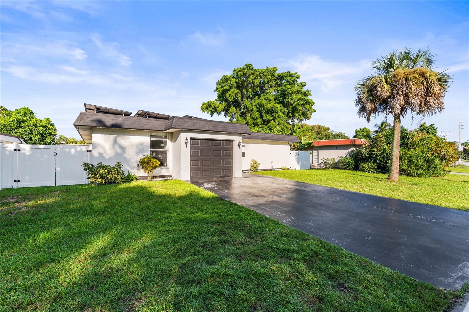 Welcome to this beautifully maintained 3-bedroom, 2-bath home in Mainlands of Tamarac Lakes, one of Tamarac’s highly desirable locations, where comfort, thoughtful updates, and Florida living come together. Major improvements include a 2019 roof, 2024 A/C, 2024 impact windows and doors, automatic irrigation, and a fully fenced/gated yard completed in 2024. Additional storm protection includes accordion shutters on the bedroom overlooking the backyard.The modern kitchen features granite countertops and updated appliances, all included with the home. A dedicated laundry closet includes a stacked washer and dryer. Recent exterior lighting (2024) creates a warm and beautiful setting in the evenings, while the fenced backyard provides a wonderful space to relax, BBQ, enjoy Florida sunrises and sunsets, and offers room for a future pool. Leased solar panels (2024) provide an additional energy-efficient feature for added peace of mind, and the existing solar lease is transferable to the new owner.The converted garage (2024) features a separate exterior entrance and offers flexible space for a workshop, hobby room, man cave, or creative studio. The ample driveway provides parking for up to four vehicles, with additional flexibility for your recreational needs.Conveniently located next to the community clubhouse and pool, the home also benefits from nearby guest parking and a clubhouse available for community gatherings and celebrations. Enjoy a well-maintained neighborhood just moments from shopping, dining, and everyday conveniences. The low-fee HOA includes common-area maintenance, lawn care, and pest control.Whether you are looking for a full-time residence, retirement home, seasonal getaway, or investment property, this home has so much to appreciate. Pack your bags and start enjoying the Florida lifestyle, beautiful sunsets, and everything South Florida has to enjoy. Convenient access to Coral Springs, Fort Lauderdale, and major highways. Property is selling AS IS.