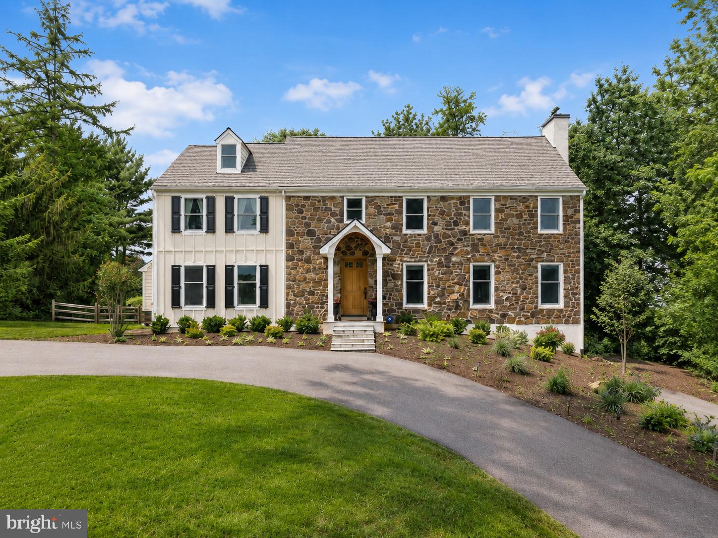 Perched atop one of the highest points in the neighborhood, this private 1.3-acre property enjoys a commanding presence, peaceful views, and a wonderful sense of seclusion. Offering classic Colonial character along with extensive recent improvements, the home feels like a tranquil retreat while remaining close to everyday amenities. With 4 bedrooms, 4 full baths, 2 powder rooms, generous living spaces, and nearly $300,000 in thoughtful upgrades by the current owners, this home beautifully blends timeless character with modern comfort.A two-story foyer welcomes you inside, where hardwood floors and traditional architectural details set the tone. The main level offers gracious formal and informal living spaces, including a large living room with one of the home’s four fireplaces, all of which have been converted to gas. From here, doors open to the covered porch, creating an easy connection to the outdoors and a wonderful place to relax while taking in the peaceful views of the property. The formal dining room features a large bay window and built-in corner cabinets, while the beautifully refreshed home office, which could also serve as a comfortable family room, features crown molding and a newly updated brick fireplace wall.The kitchen, fully renovated in 2019, is both functional and stylish, with updated finishes, stainless steel appliances, quartz counters, a separate pantry, and abundant storage. The stone-flanked fireplace creates a warm and inviting setting for everyday meals and casual gatherings. An eat-in breakfast area and convenient wet/dry bar with a beverage fridge, overlook the backyard.  With direct access to the patio, the kitchen becomes a natural gathering place and makes indoor-outdoor entertaining effortless. A laundry room and two powder rooms complete the first floor.Upstairs, you’ll find four bedrooms, including a spacious primary suite set apart from the other bedrooms. This private retreat features walk-in and traditional closets, his-and-her bathrooms, and the home's fourth gas fireplace. Three additional bedrooms, one with an en-suite bath and two connected by a Jack-and-Jill bath, provide comfortable space for family, guests, or additional office needs. A full walk-up attic spans the length and width of the home, offering exceptional storage and potential for future finished living space.The finished lower level adds nearly 800 sf of flex space with room for recreation, fitness, and storage. A sauna was installed in 2023, and in 2024, a new heating and air conditioning system was added, and heat was extended to the basement, enhancing the comfort and usability of this level. The attached two-car garage is also accessible from here.The exterior has been substantially improved and beautifully refreshed. Updates include a full replacement of the previous stucco with Hardie® Plank lap siding, Hardie® trim boards and board-and-batten vertical siding, new gutters,  new shutters, two new chimney caps, a roof portico, new porch columns,  a new blue stone  front porch with slate steps, and a custom mahogany front door, the perfect welcoming entry. The property also features a fenced-in backyard with post-and-rail fencing, newly milled and repaved asphalt driveways with ample guest parking, and new landscaping in the front of the home.Major upgrades continue throughout the home, including 43 new Andersen 400 Series windows, two new back patio doors, a new water well pump, a water softener system, and conversion from septic to public sewer for added convenience Private, updated, and full of character, this home offers the best of both worlds: the charm and presence of a classic Colonial with the comfort of meaningful modern improvements. Ideally located near premier shopping, dining and major commuter routes and just about a mile to Episcopal Academy, this is a truly special property designed for everyday living, easy entertaining, and quiet enjoyment. The family room photo is virtually staged.