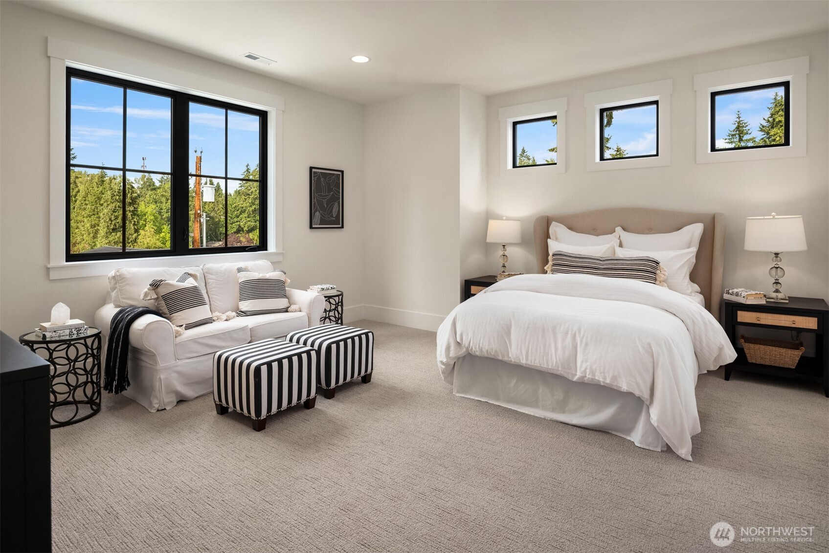 Light-filled bedroom with large windows.