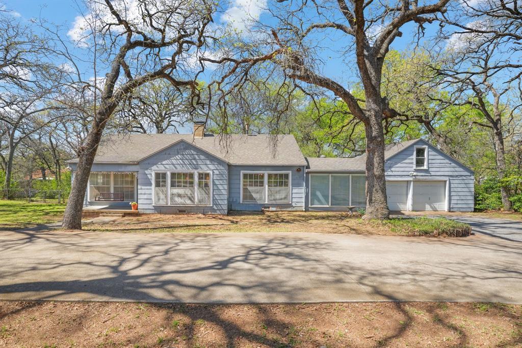 Charming River Oaks Home on a Rare .61 Acre Treed Lot!Welcome to 825 Sam Calloway Road in Fort Worth, a beautifully maintained 3 bedroom, 2 bathroom home full of character, space, and timeless craftsmanship. Nestled on an expansive .61 acre lot shaded by mature trees, this property offers the perfect blend of classic charm and modern livability.Step inside to discover original hardwood floors and stunning carpentry throughout, creating warmth and character rarely found in homes today. The inviting living room features a cozy fireplace, perfect for relaxing evenings, while a second living area offers flexible space for a game room, office, or additional entertaining area.The home also features a large formal dining room ideal for hosting gatherings and holiday meals. The spacious kitchen is truly a chef’s dream, offering plenty of room to cook and entertain, highlighted by a large picture window above the sink overlooking the backyard.Practicality meets functionality with an oversized laundry room and a oversized two-car garage complete with a loft for additional storage or workspace.Outside, enjoy the peaceful setting of your large treed lot with a circular front driveway, providing plenty of parking and a welcoming first impression.Located in the desirable River Oaks neighborhood, this home is just minutes from some of Fort Worth’s best outdoor destinations including Trinity River walking trails, Airfield Falls Trailhead & Park, Hawks Creek Golf Club, Burgers Lake, and YMCA Camp Carter. You'll also enjoy quick access to Highway 820 and I-30, making commuting simple while still being close to great restaurants, shopping, and entertainment.This property offers a rare opportunity to own a spacious lot, classic craftsmanship, and an unbeatable location all in one.