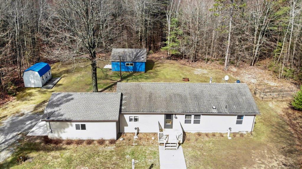 Tucked away on 5 beautifully wooded acres, this inviting 3-bedroom, 2-bath home offers the perfect blend of privacy, space, and convenience. Surrounded by nature, you'll enjoy peaceful mornings, abundant wildlife, and room to roam, all while being just minutes from everything you need.  Inside, the home provides a comfortable and functional layout, ideal for everyday living or a relaxing up-north getaway. An attached garage adds convenience, while the impressive 24 x 30 detached garage offers plenty of space for vehicles, boats, or all your recreational toys. A large shed provides even more storage for tools and equipment.  Located just 3 miles from Houghton Lake, you're never far from boating, fishing, dining, shopping, and year-round entertainment. Whether you're looking for a full-time residence or a weekend retreat, this property delivers both comfort and versatility.  For those wanting even more space, an additional 5-acre parcel is available, giving you the opportunity to expand your private retreat or invest in future possibilities.